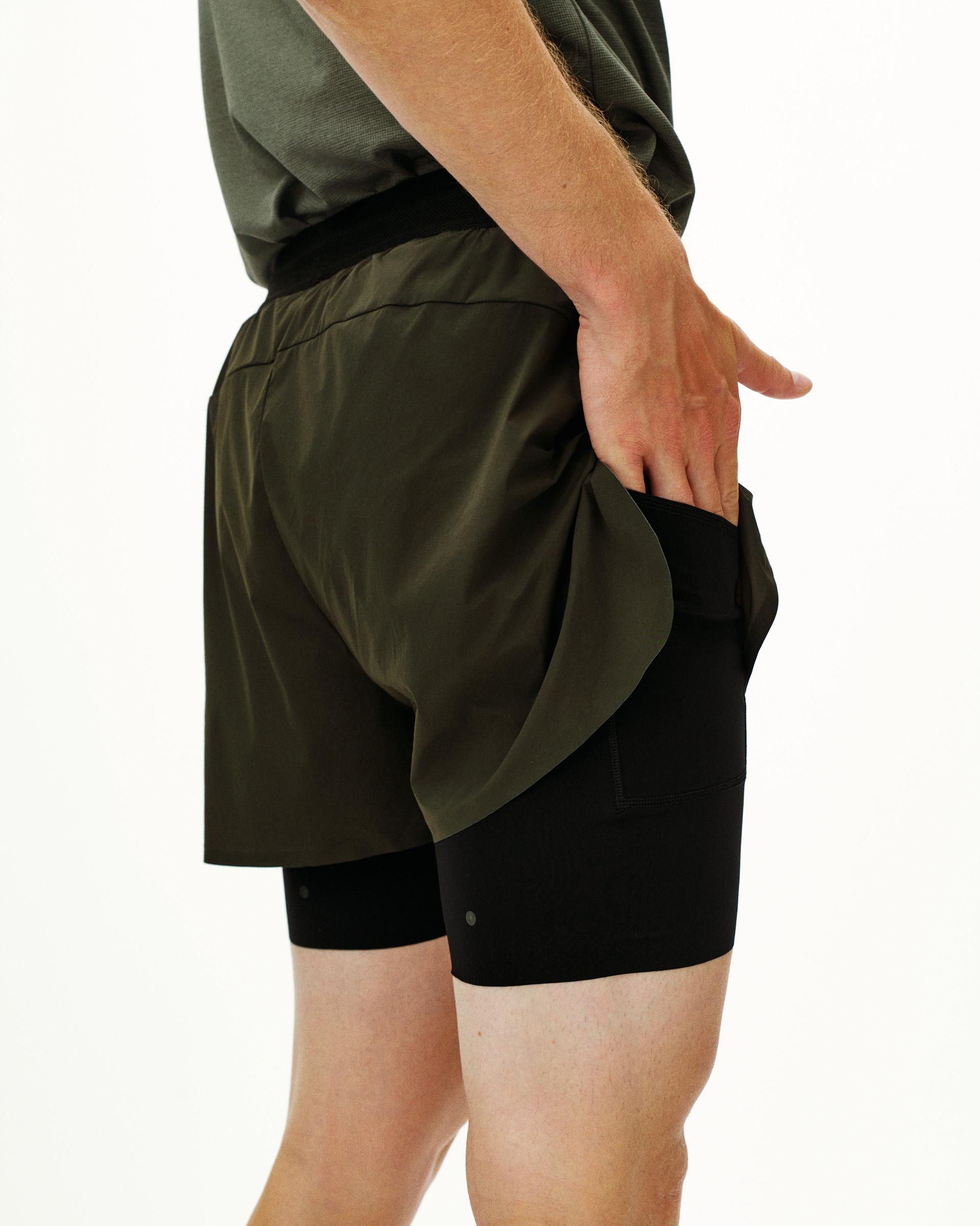 Dark Olive Balance 2-in-1 shorts on model showing outer shell and inner compression layer