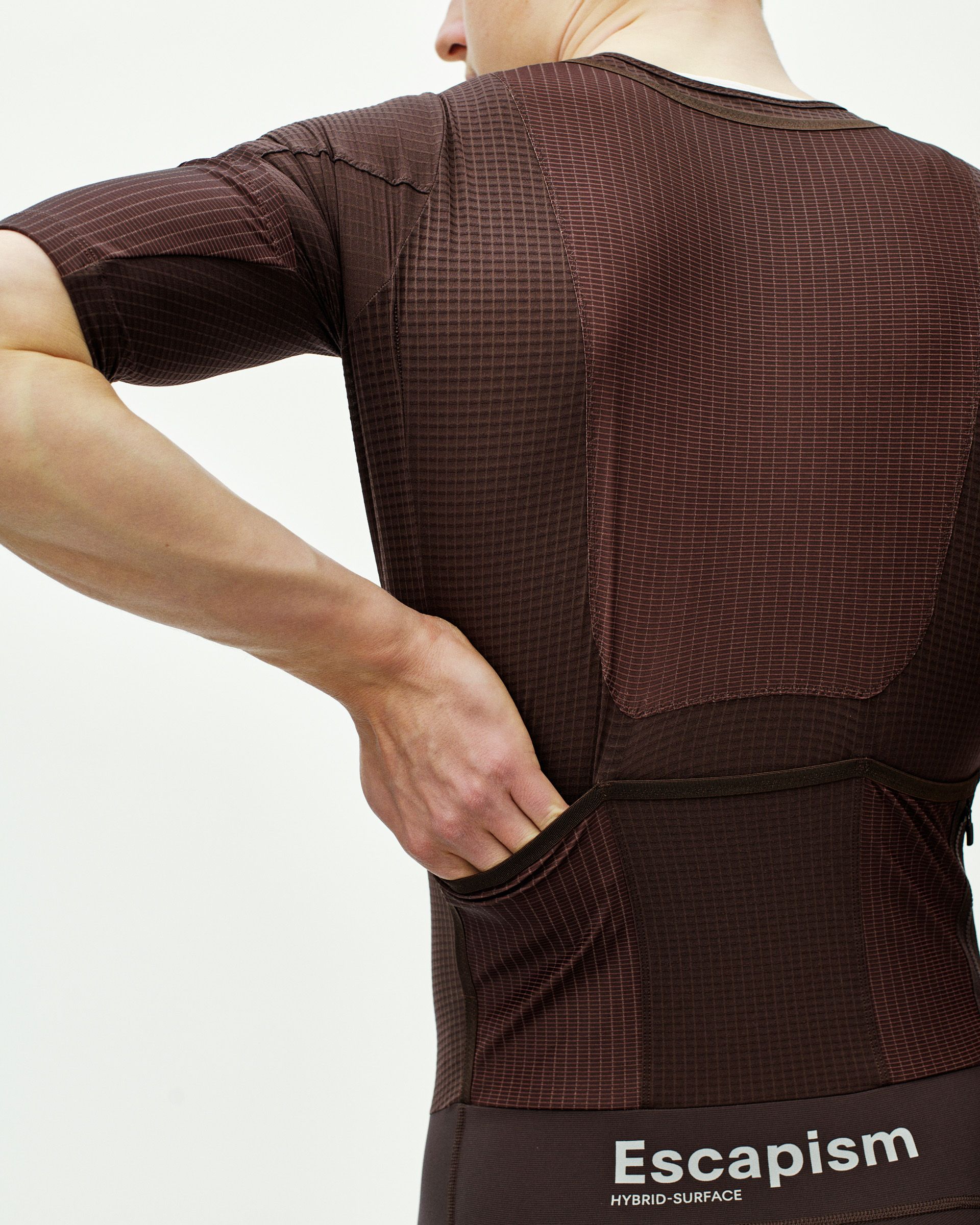 Dark Red Escapism speedsuit on model, rear view with ripstop panels and rear pockets