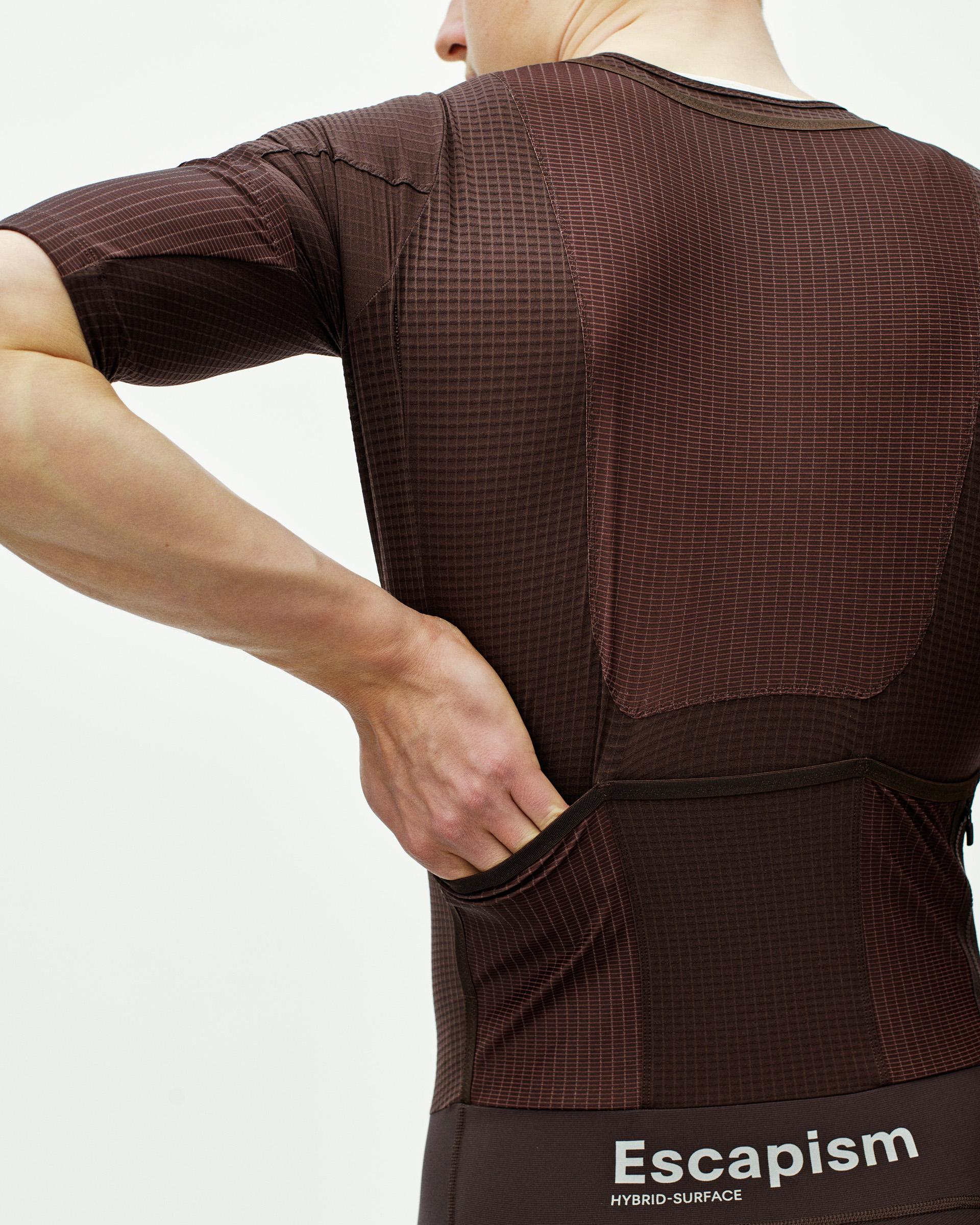 Dark Red Escapism speedsuit on model, rear view with ripstop panels and rear pockets