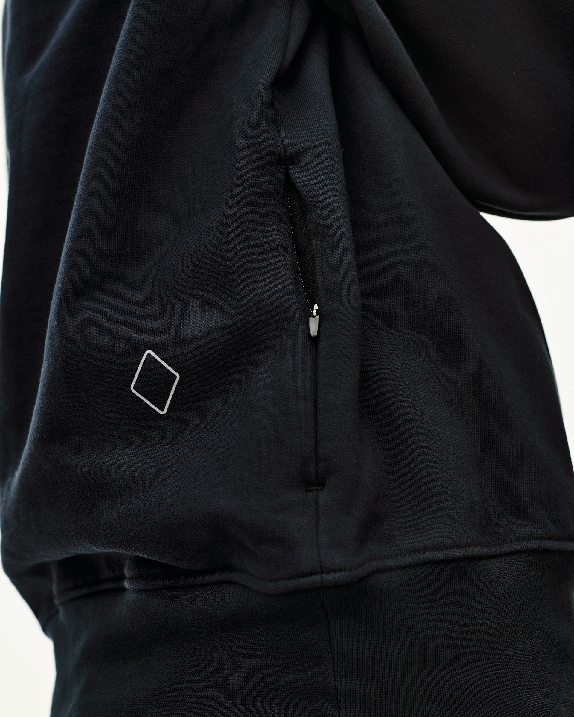 Black Off-Race sweatshirt, detail view of side zip pocket and diamond logo patch