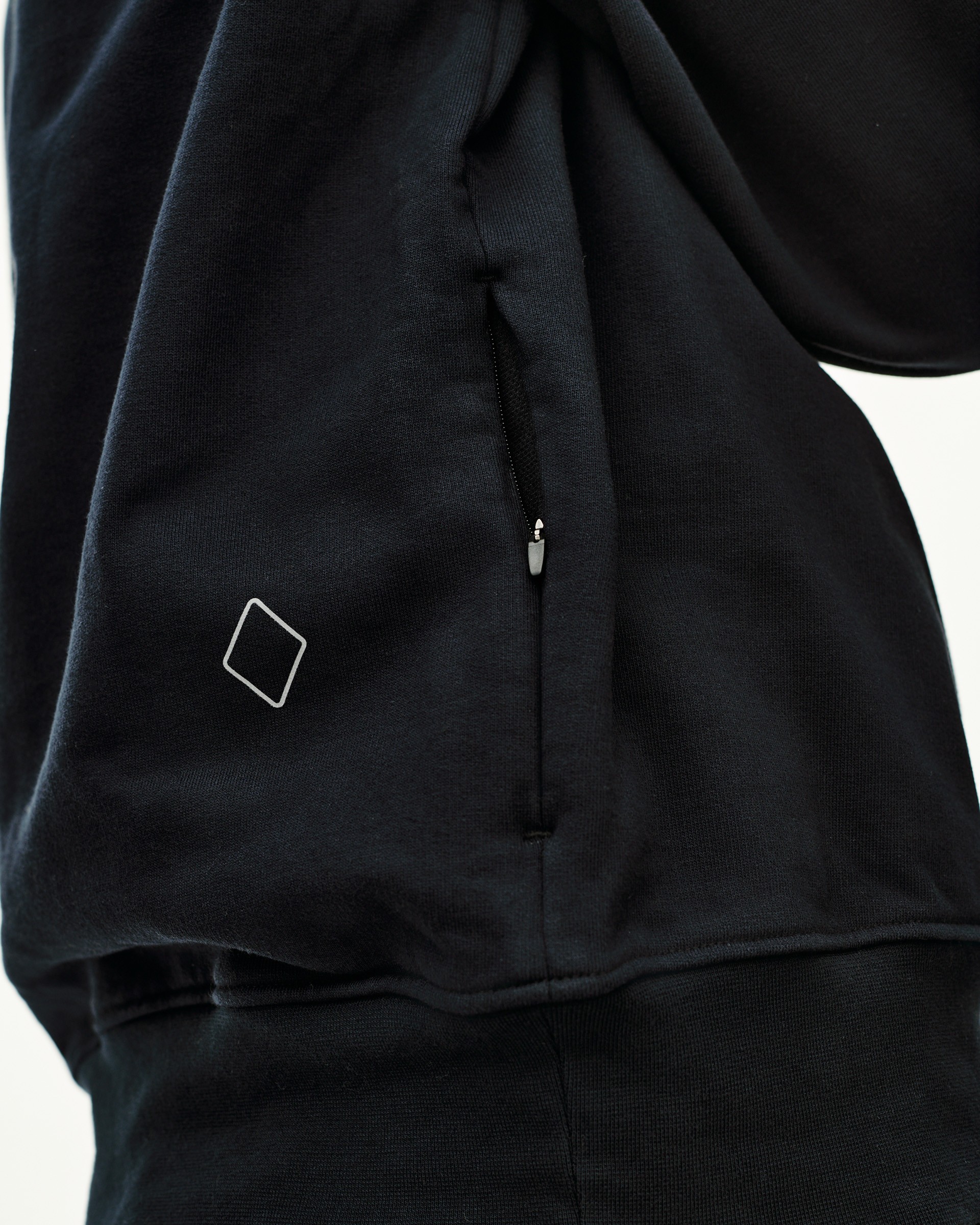 Black Off-Race sweatshirt, detail view of side zip pocket and diamond logo patch