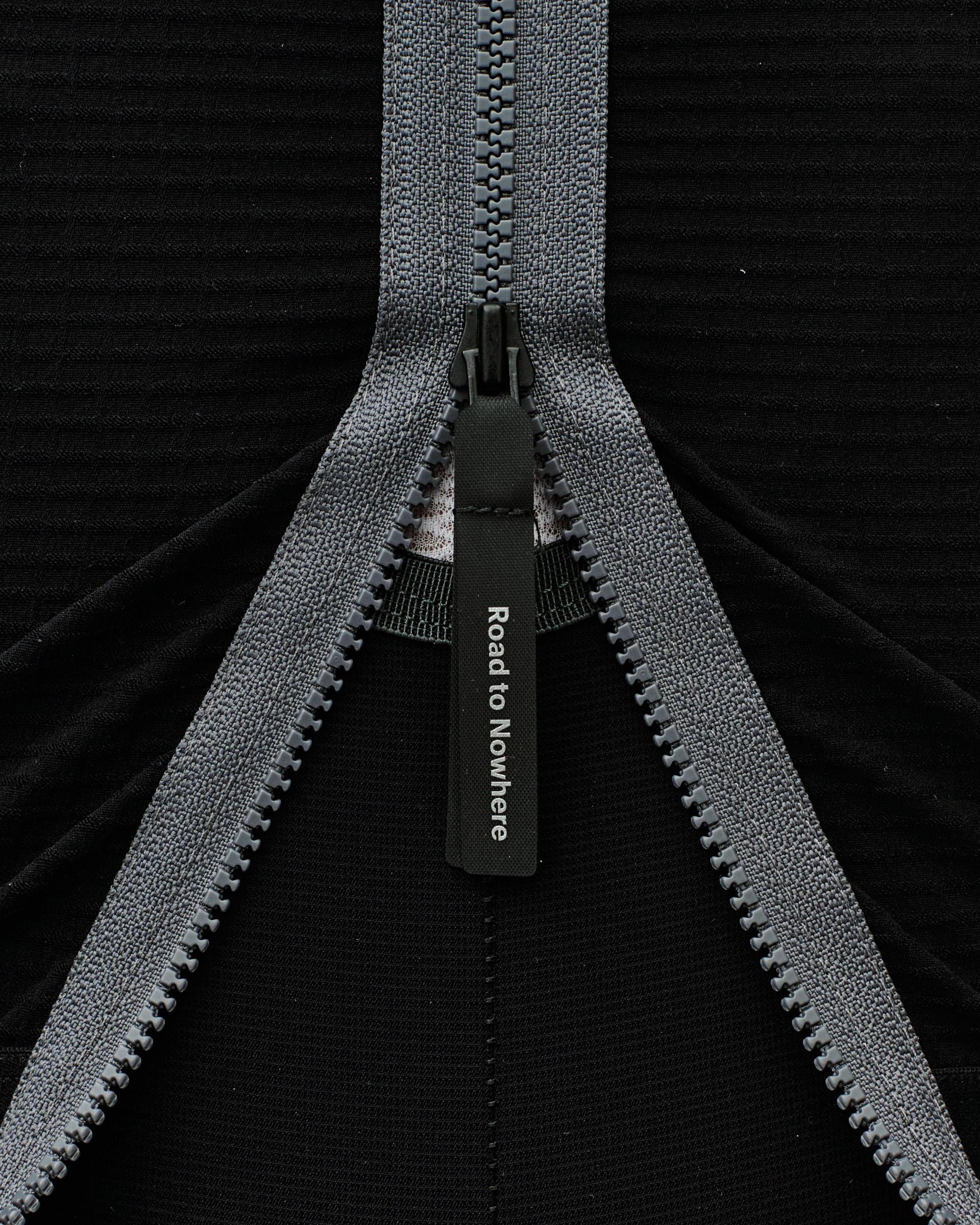 Two-way zipper with grey tape and black pull tab on dark fabric for adjustable ventilation