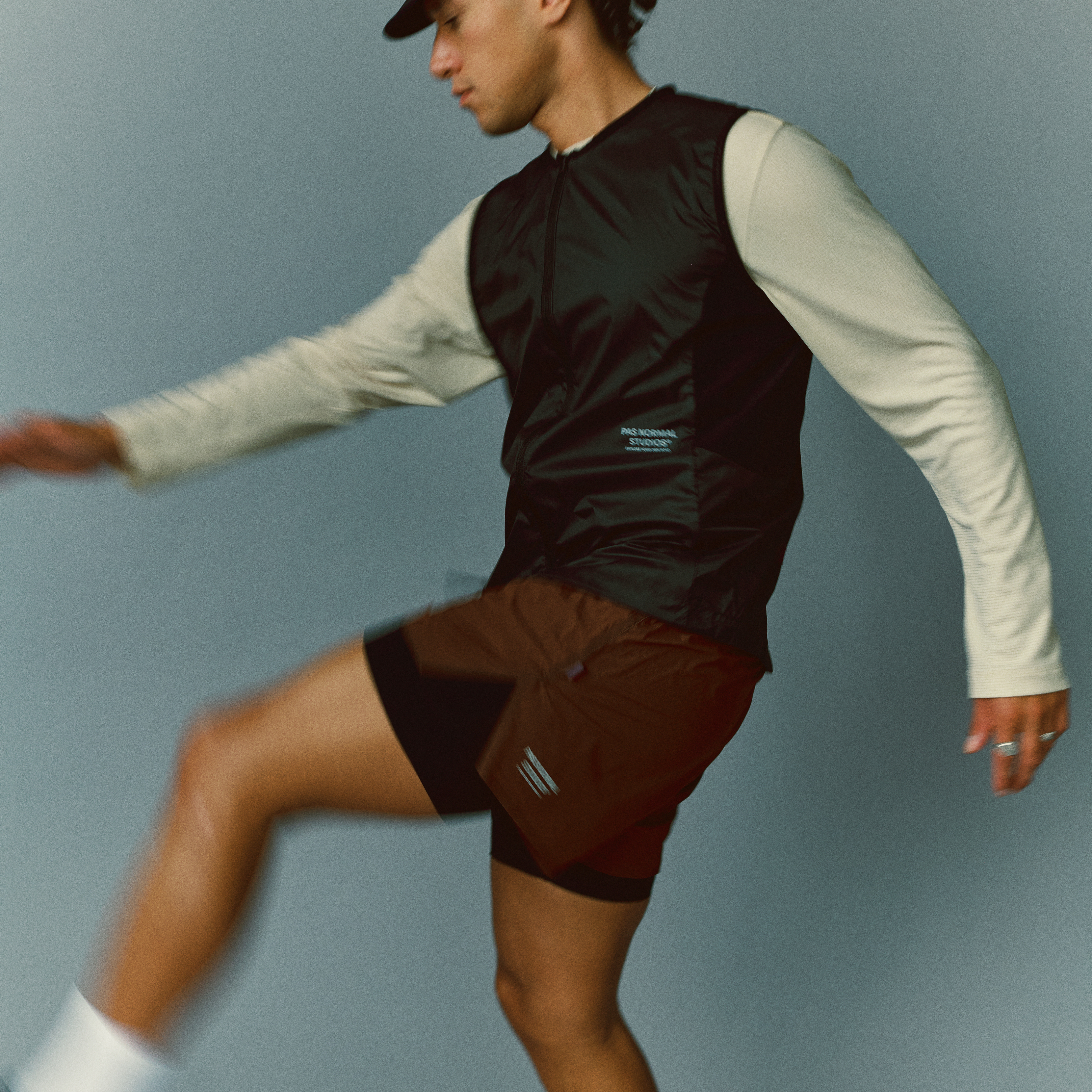 Rust red Balance men's shorts on model, side view with liner visible beneath outer short