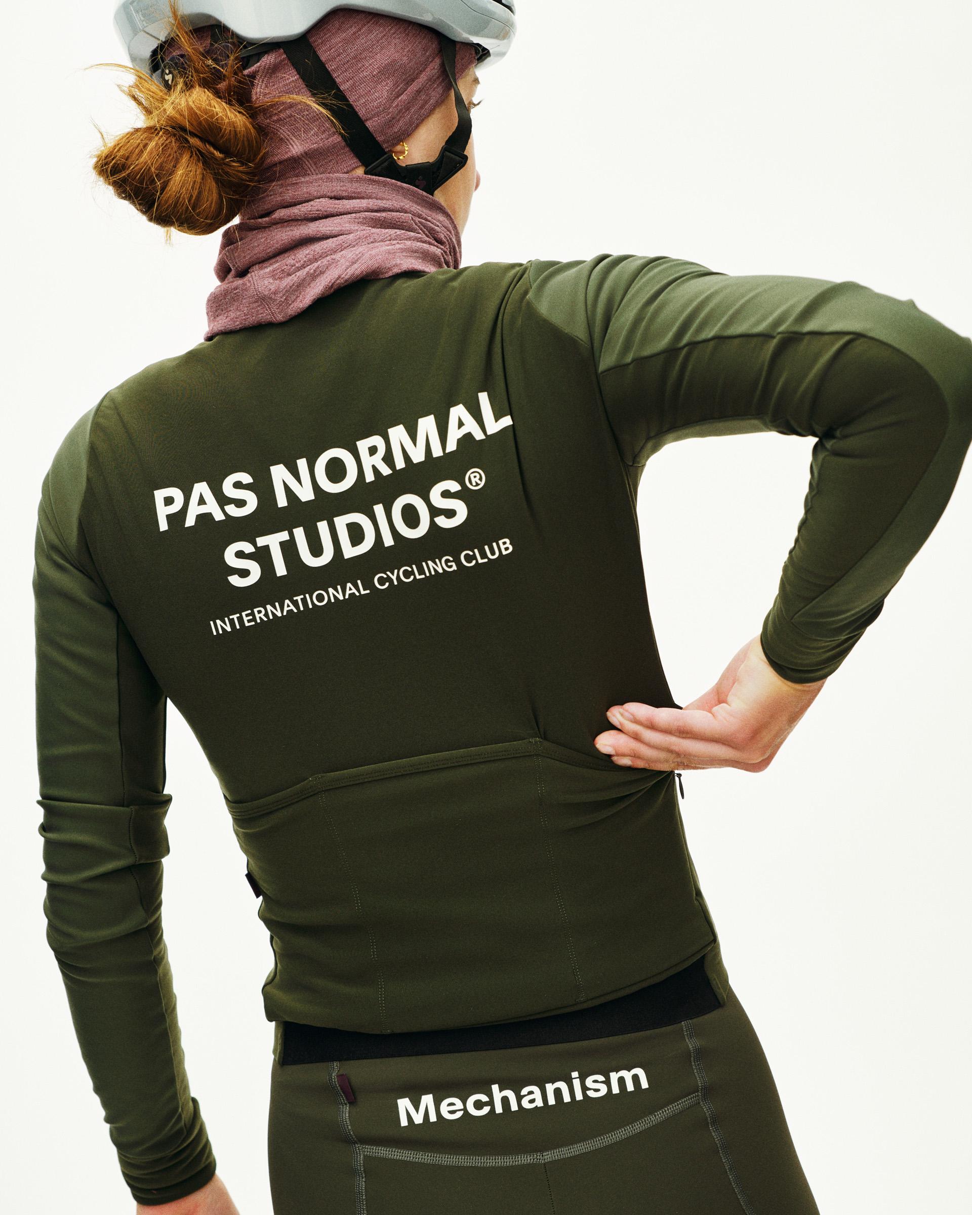 Dark Olive Mechanism Thermal long sleeve cycling jersey, rear view on model with white back logo