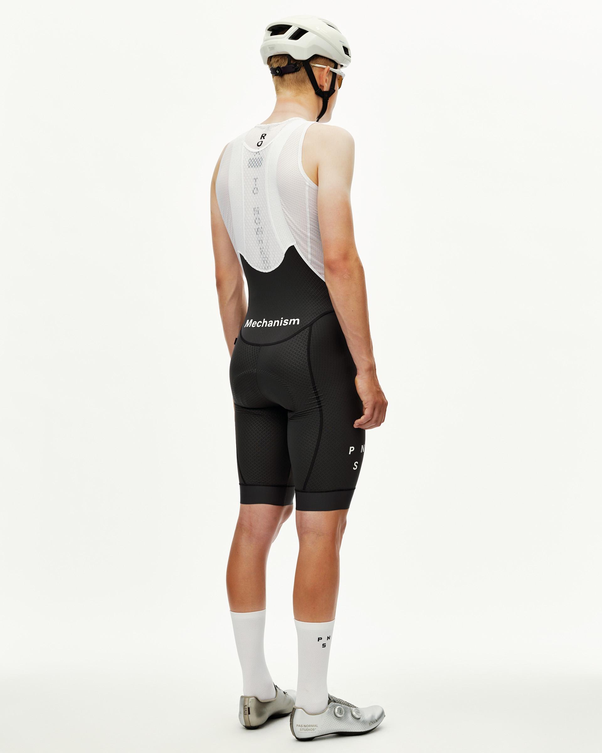 Dark Navy Mechanism cycling bibs on model, rear view with white logo print