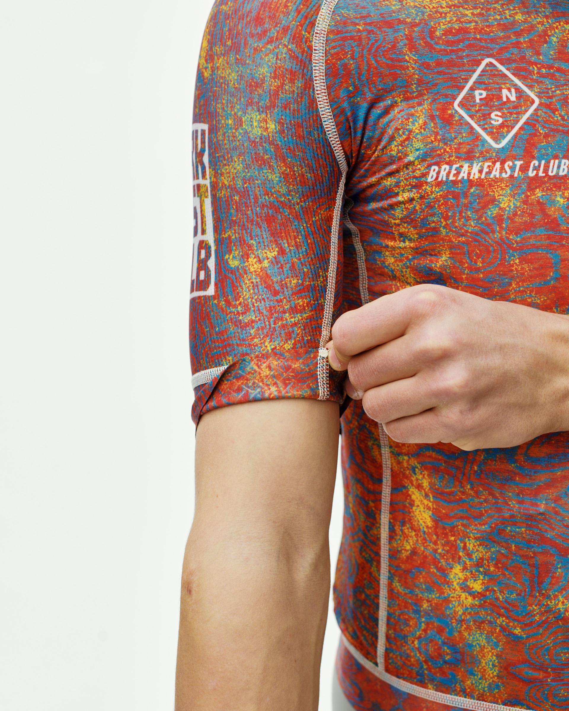 Breakfast Club Mechanism cycling jersey on model with psychedelic grain print and contrast stitching