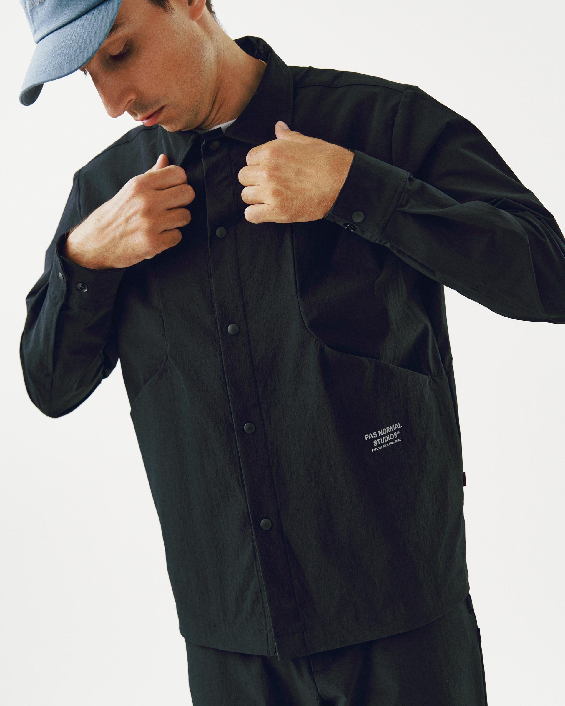 Black Off-Race Tech Overshirt on model adjusting collar with snap button closure
