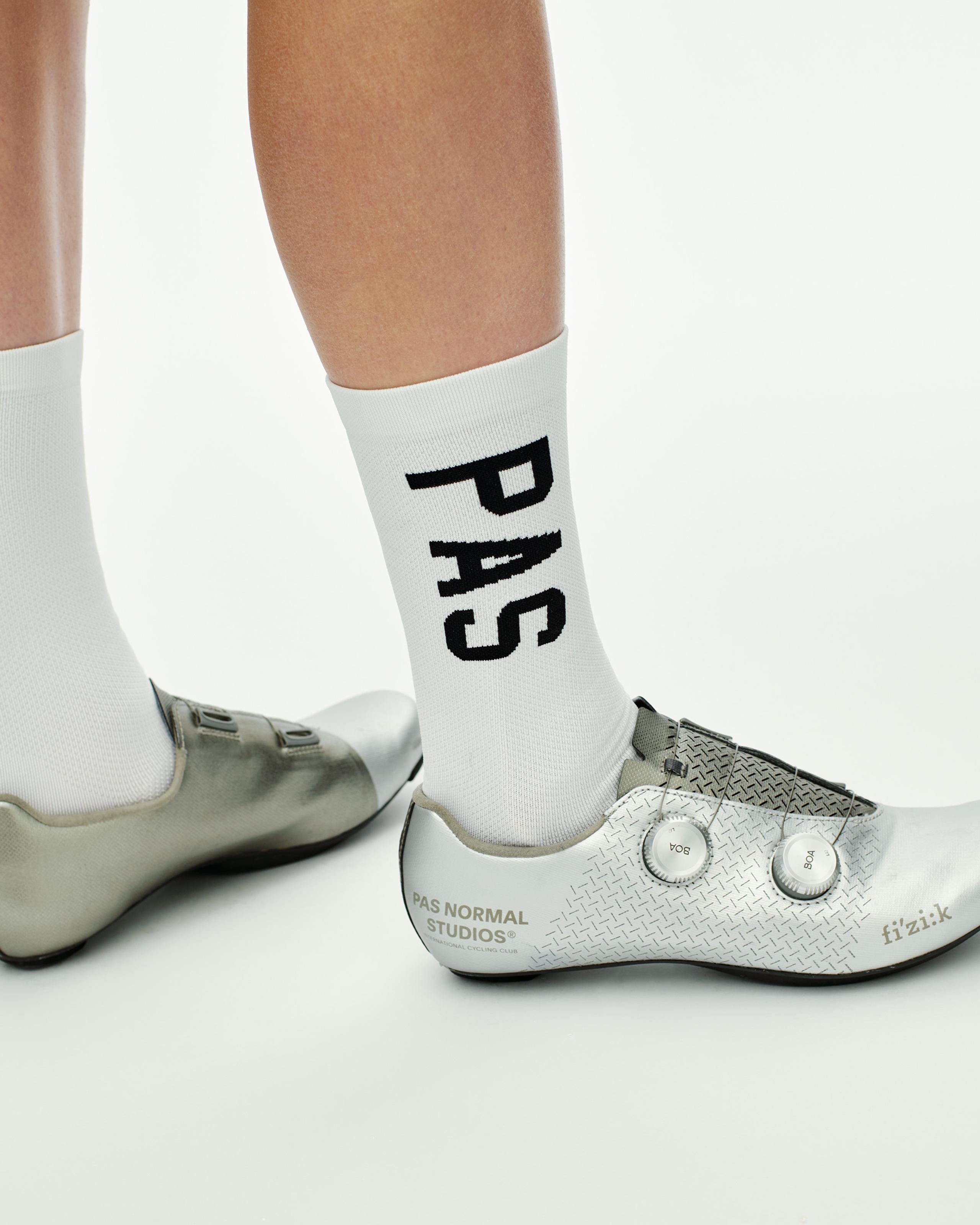 White PAS Race cycling socks on model with black logo text