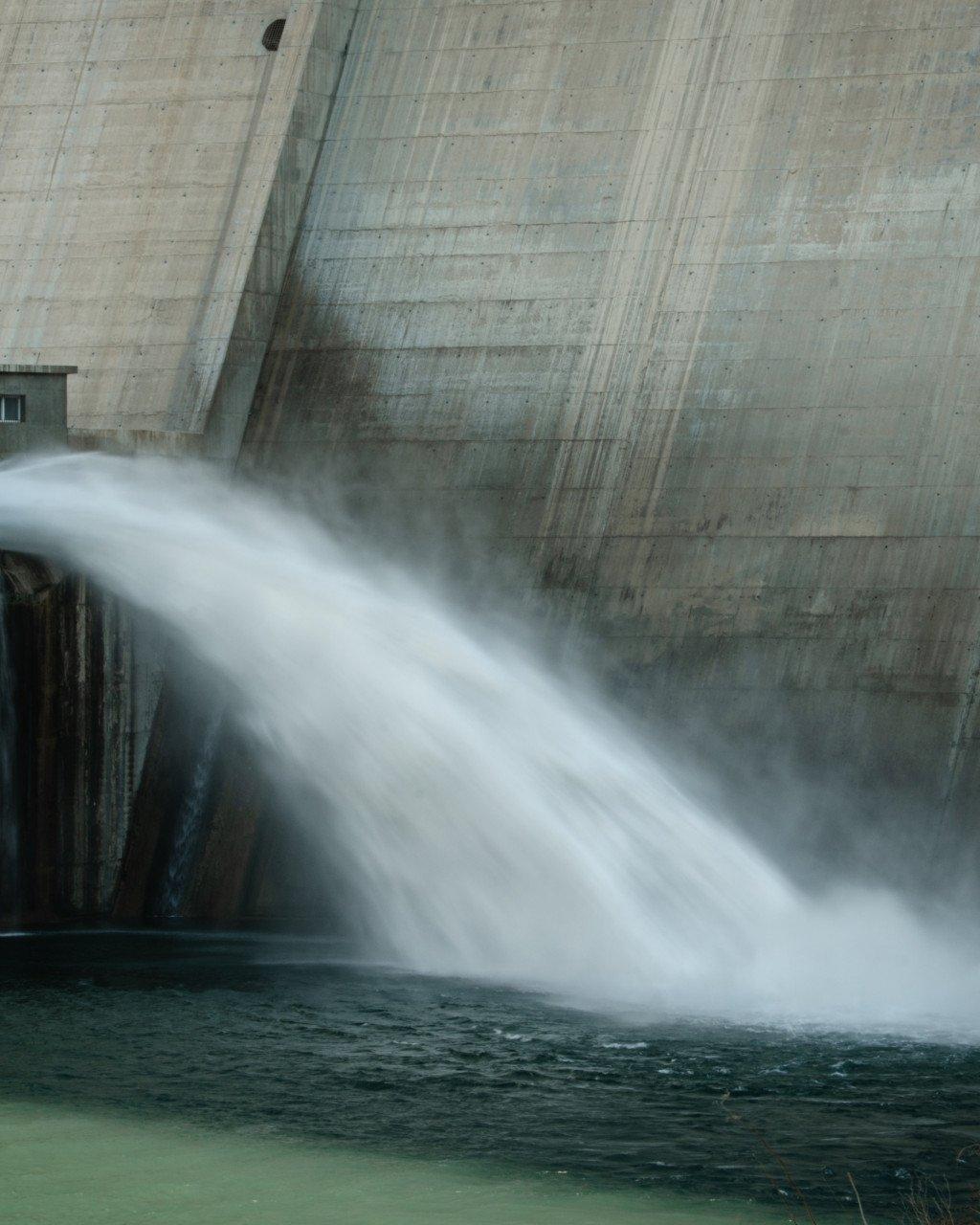 Water flowing from concrete dam structure