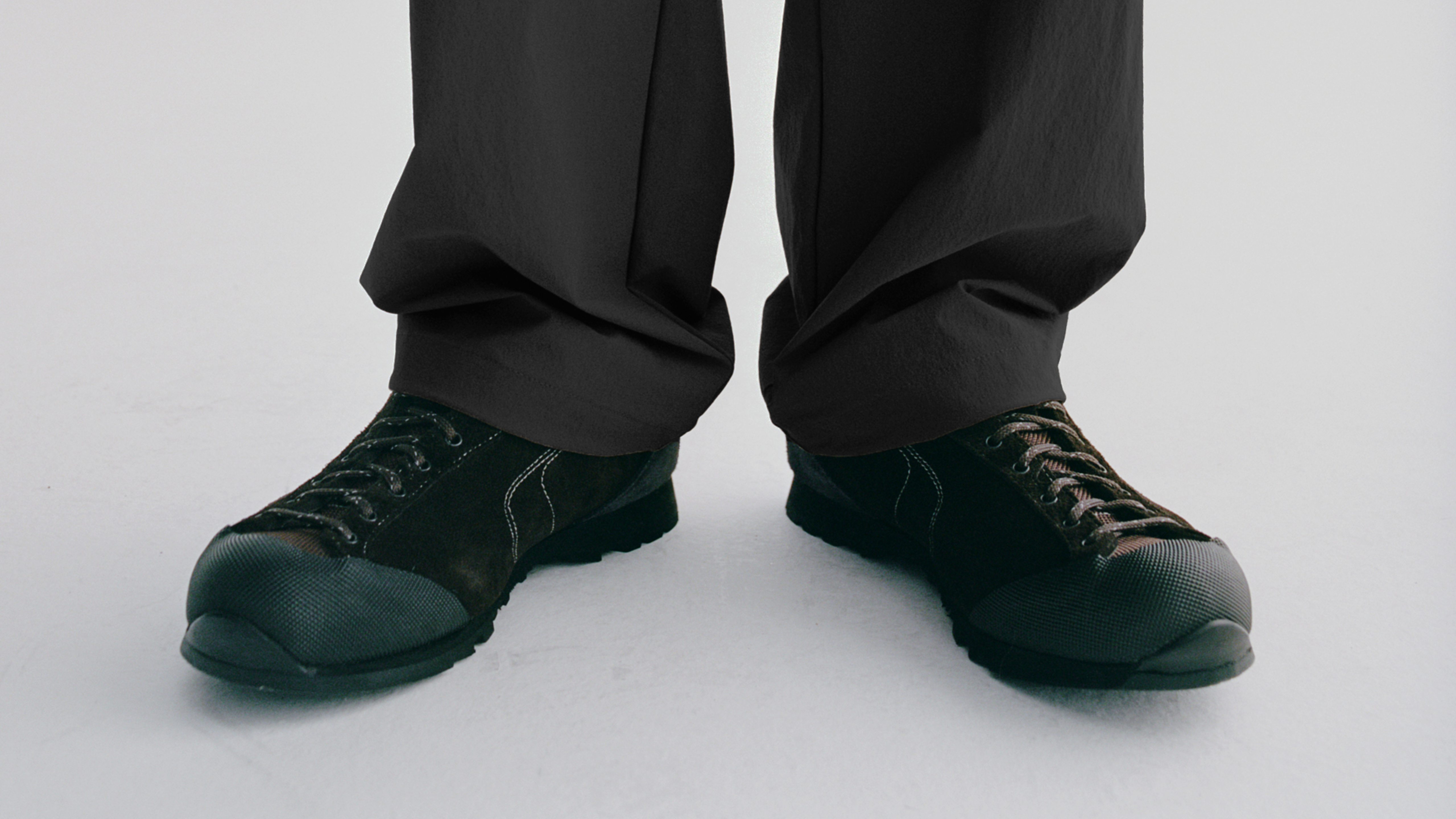 Dark cycling shoes with lace-up design worn with black pants