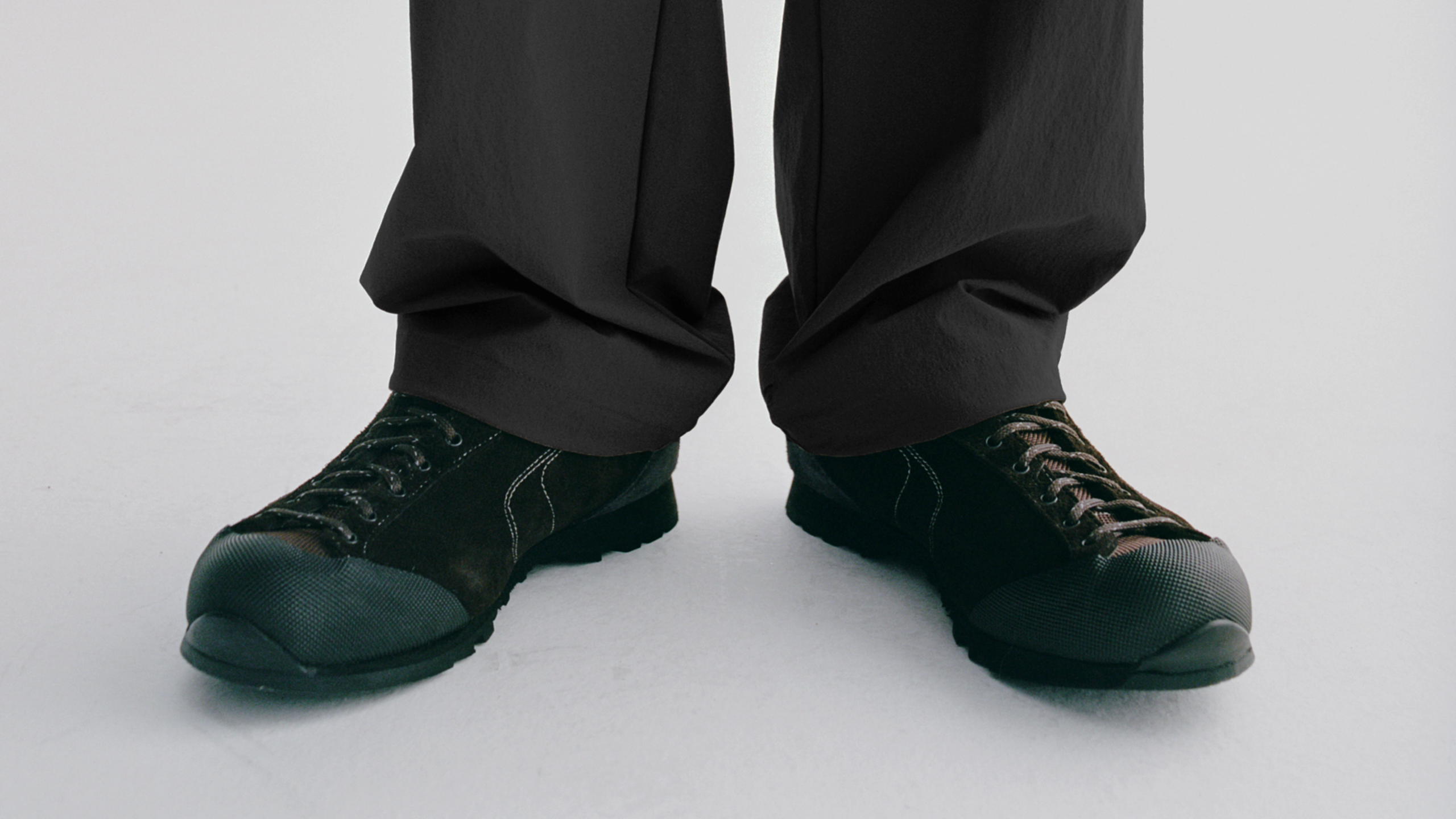 Dark cycling shoes with lace-up design worn with black pants