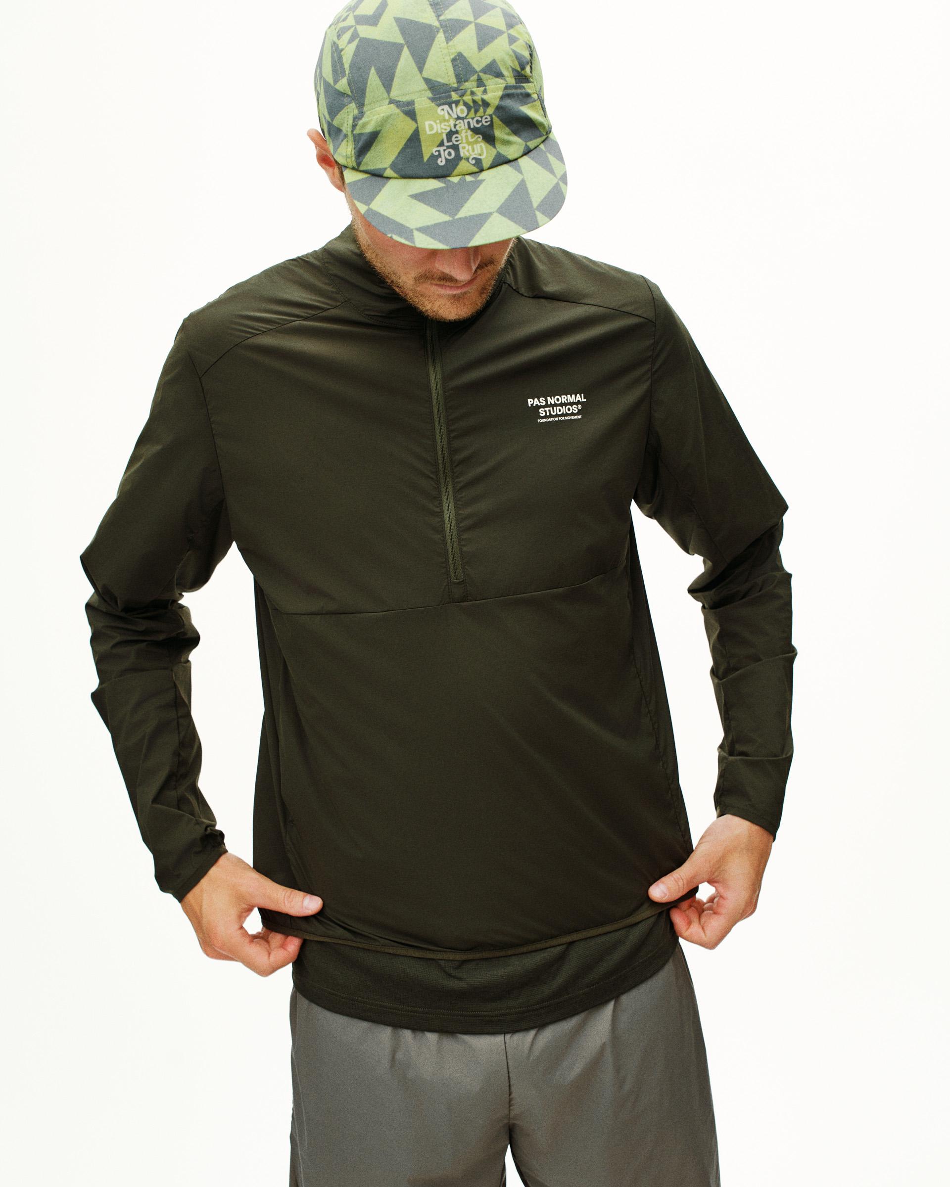 Dark Olive Balance Half Zip jacket on model with quarter zip and white chest logo
