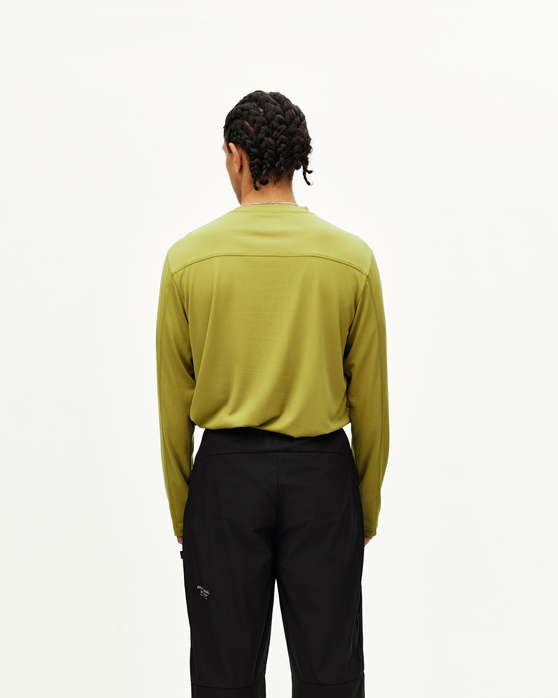 Black Balance performance pants on model, rear view with side utility pocket detail