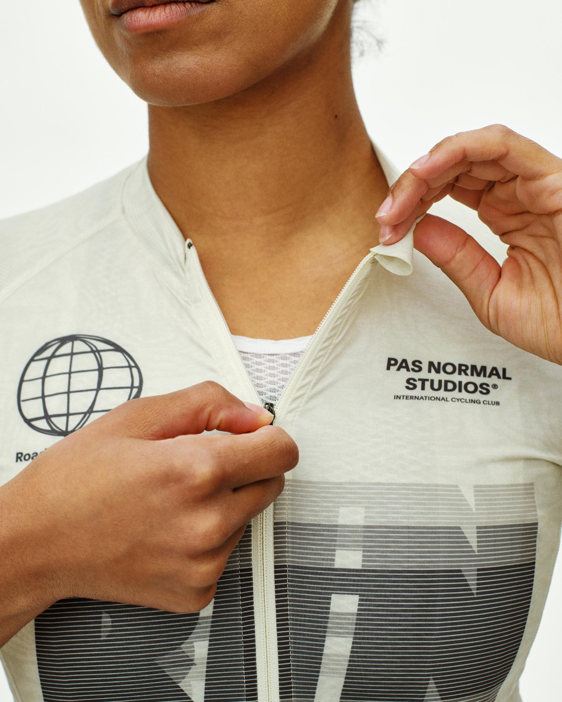 Off White Mechanism Logo women's cycling jersey, front detail on model with zip and globe graphic chest print