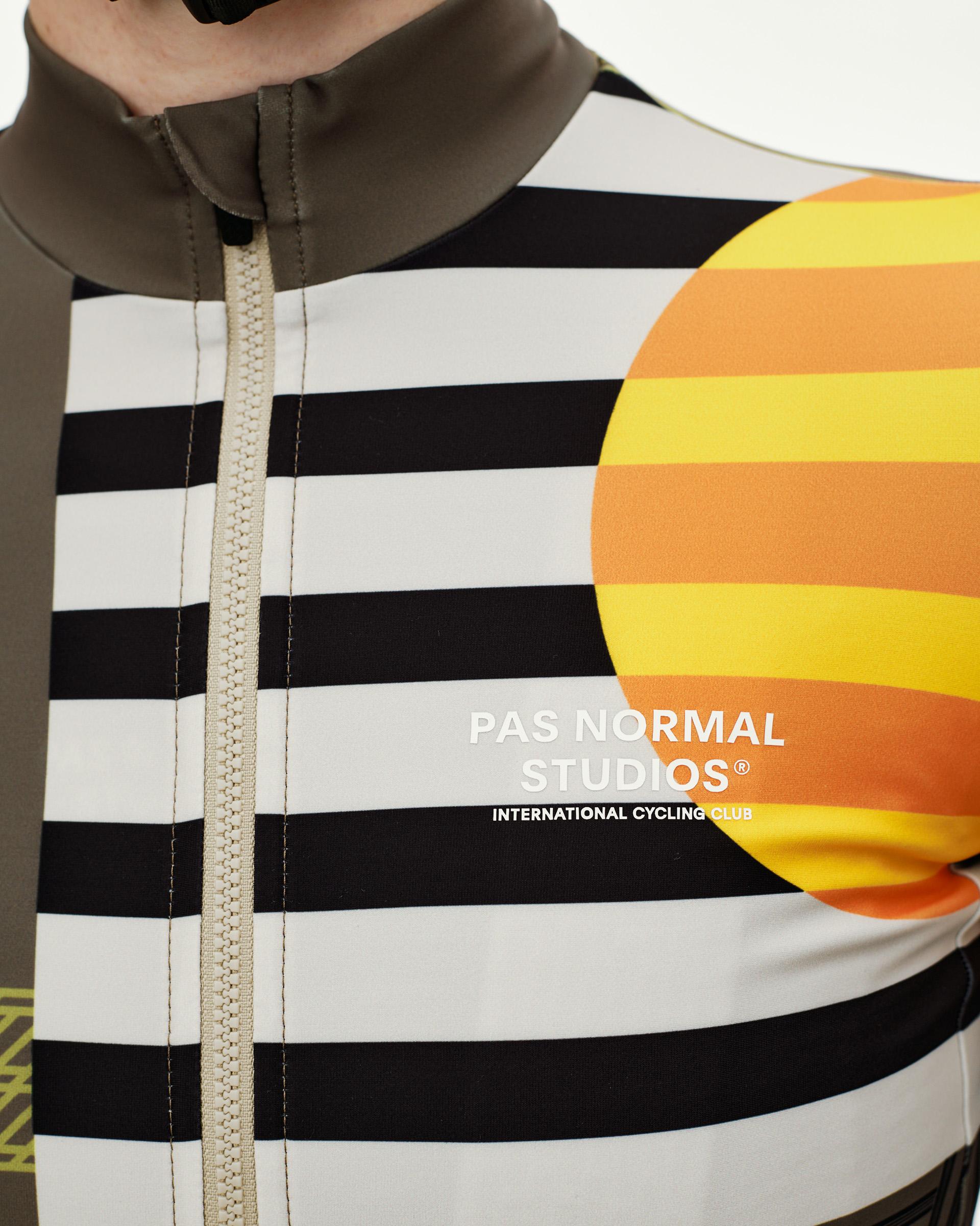 International Sand Mechanism long sleeve cycling jersey, front detail on model with black stripe and sun graphic print