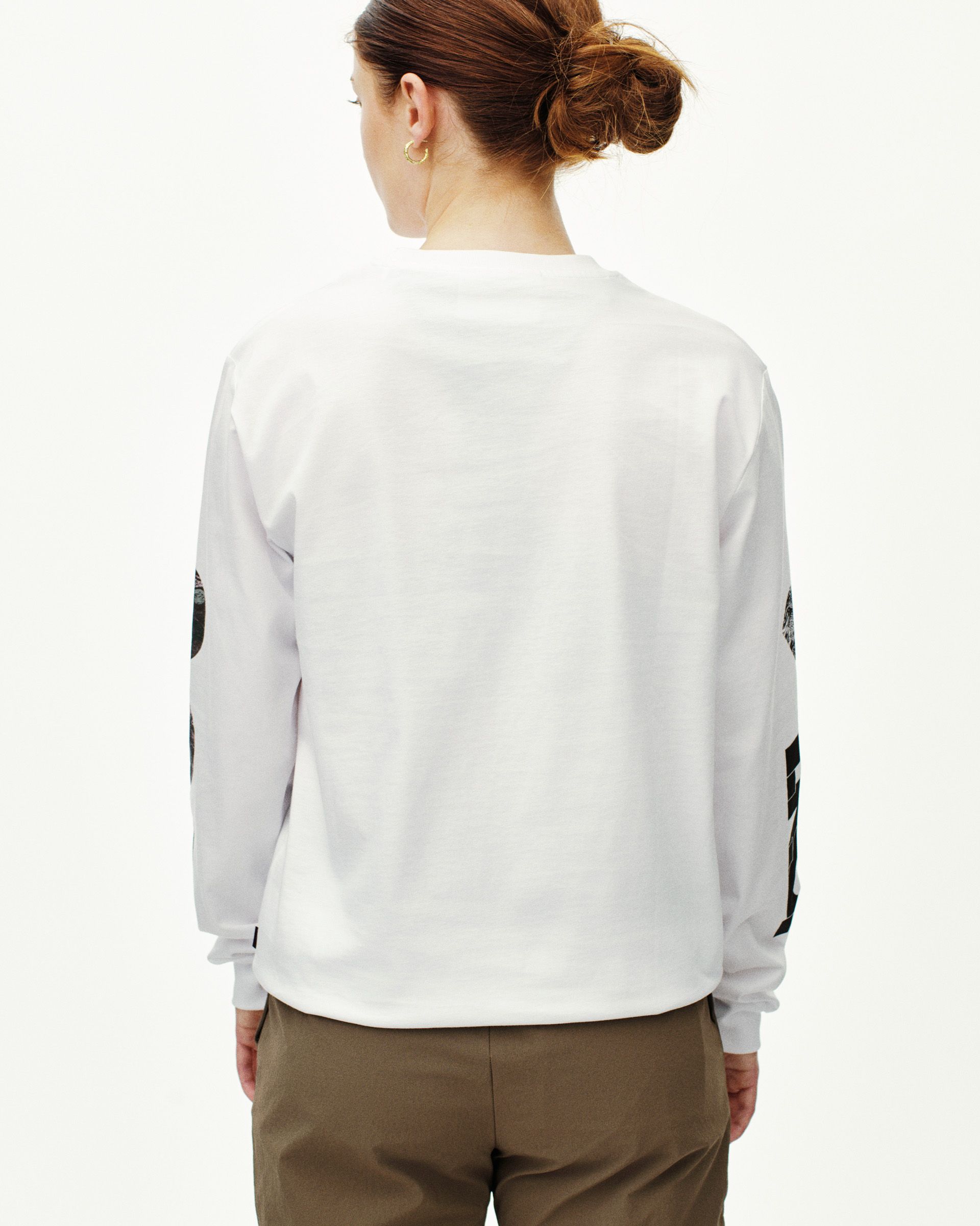 White T.K.O. Off-Race long sleeve T-shirt on model, rear view with black graphic sleeve print
