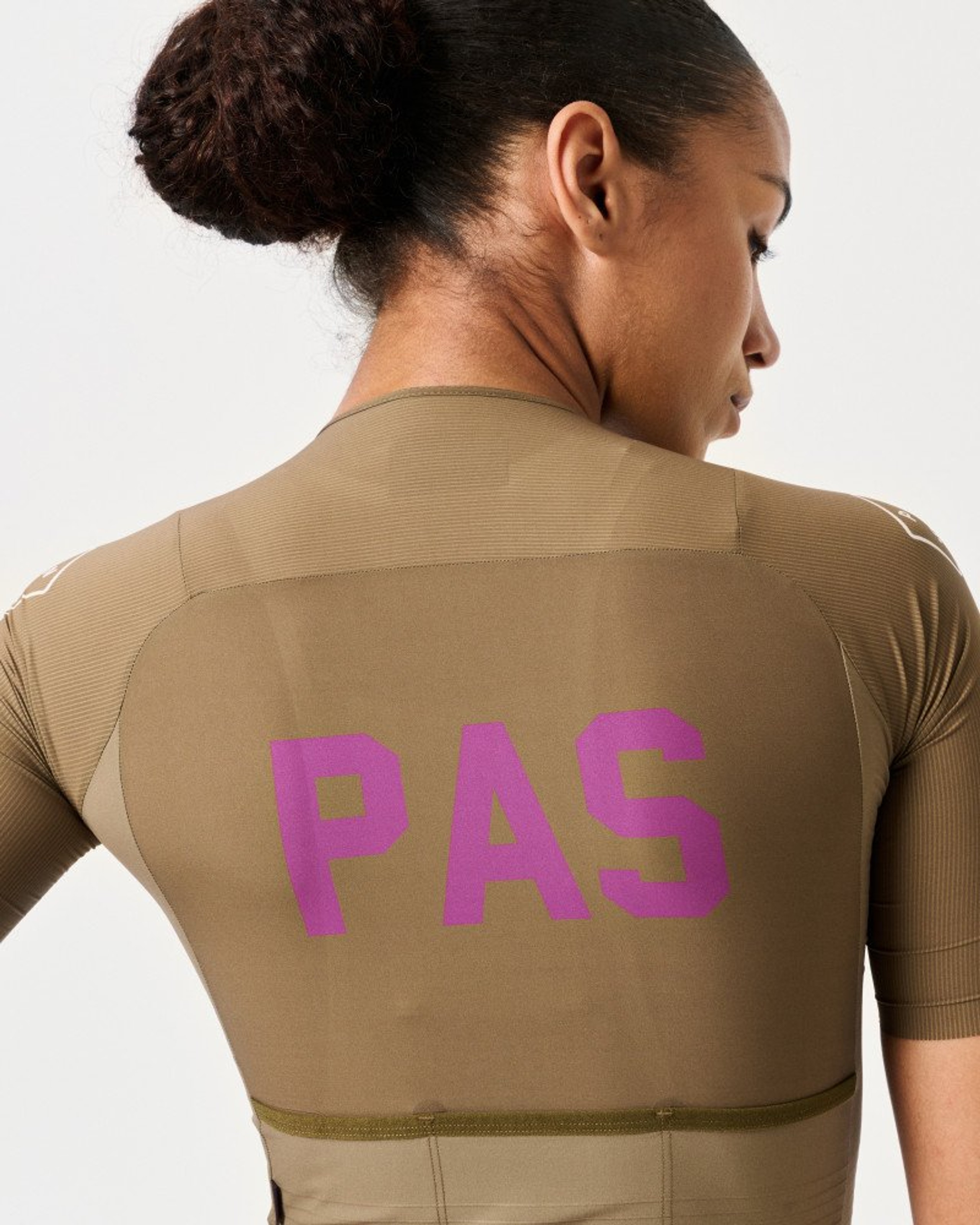 Beech PAS cycling jersey on model, rear view with purple back logo