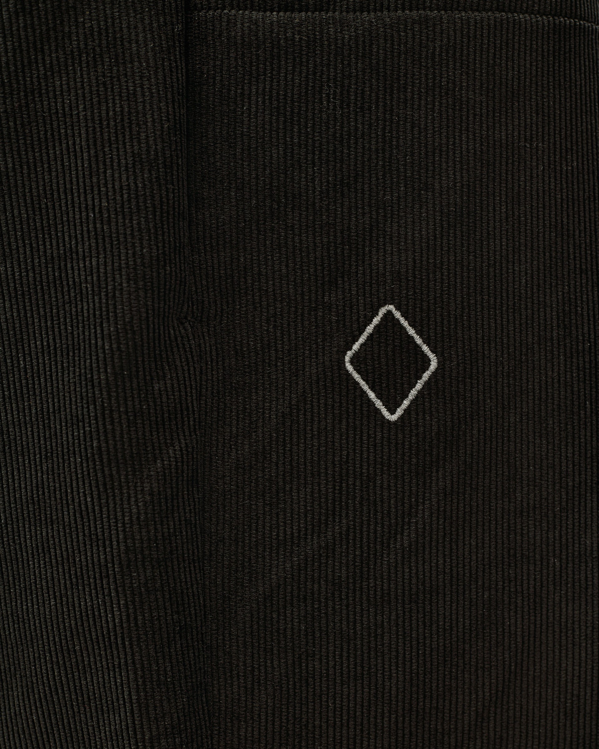 Black Off-Race Corduroy pants, detail view of corduroy texture with embroidered diamond logo