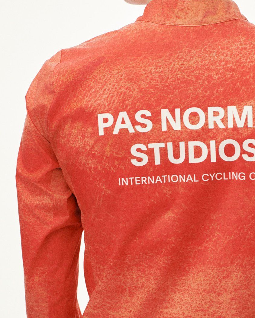 Orange Mechanism Stow Away jacket, rear view with white chest print