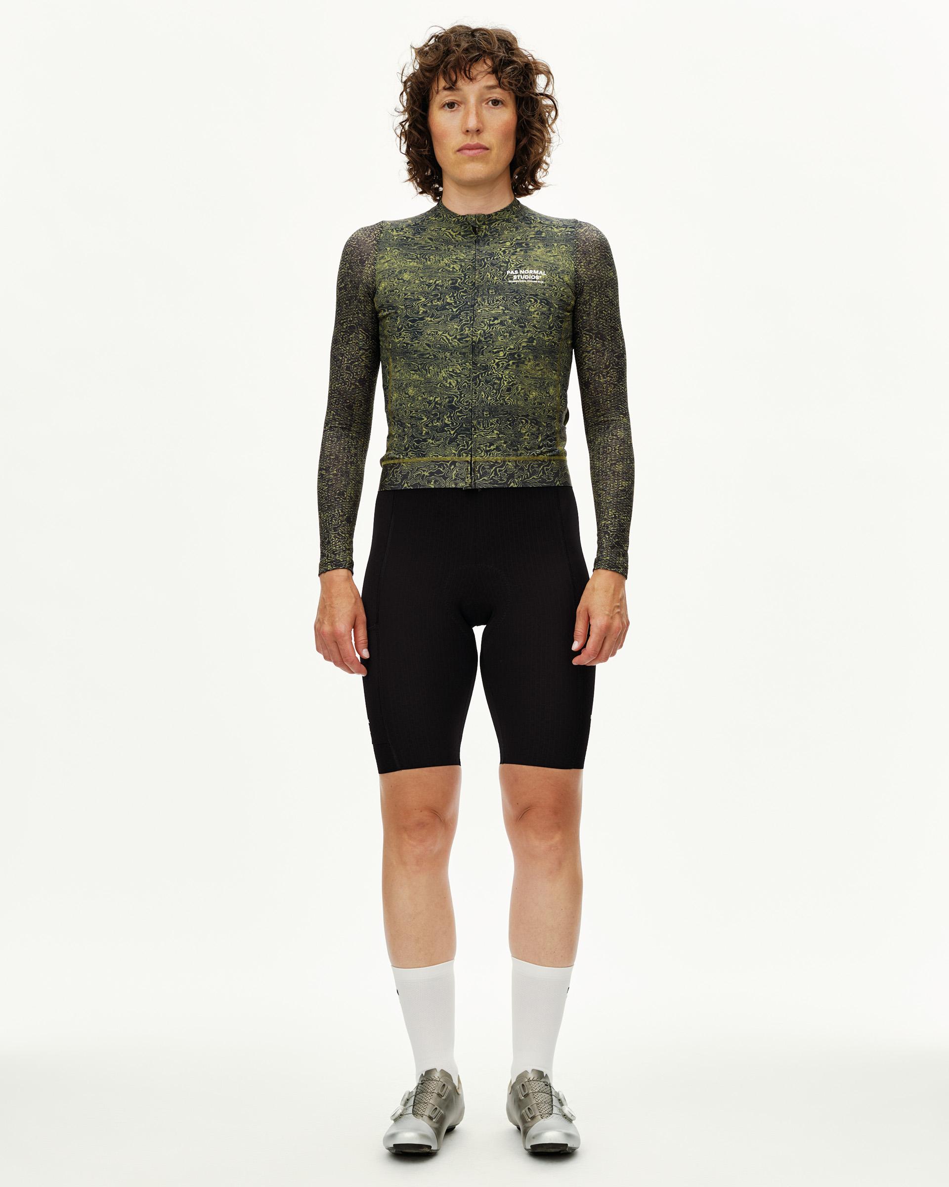 Dark Lime Essential long sleeve cycling jersey on model, front view with all-over swirl print