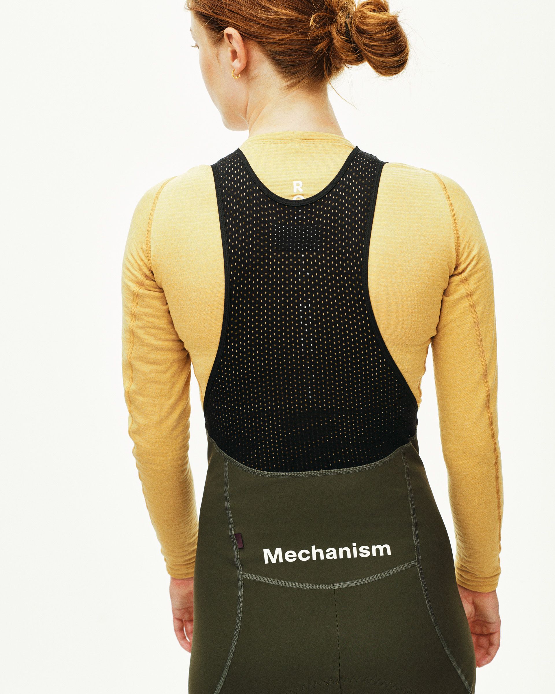 Camel Thermal Long Sleeve base layer on model, rear view with black mesh vest overlay