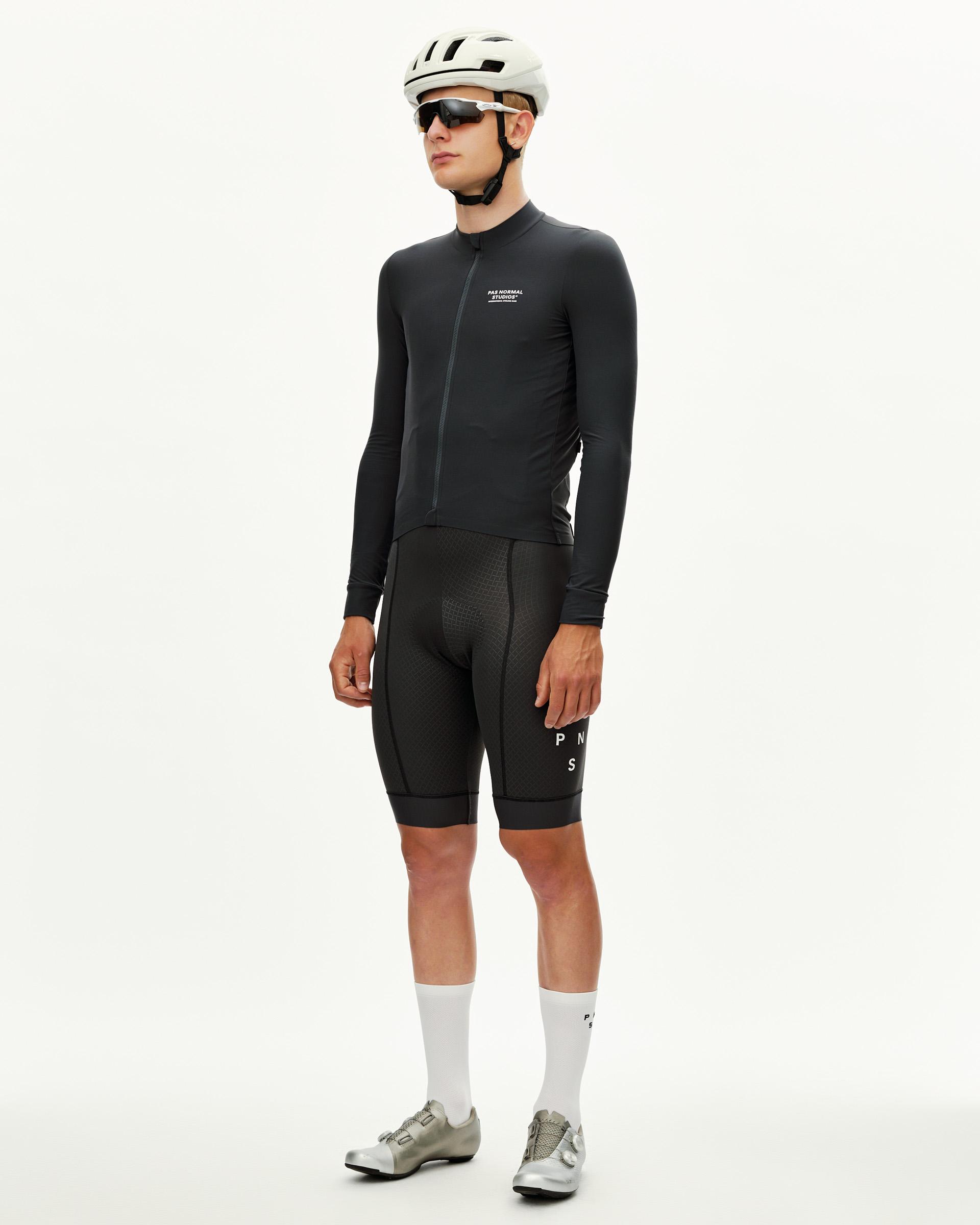 Dark Navy Mechanism long sleeve cycling jersey on model, front three-quarter view with chest logo print