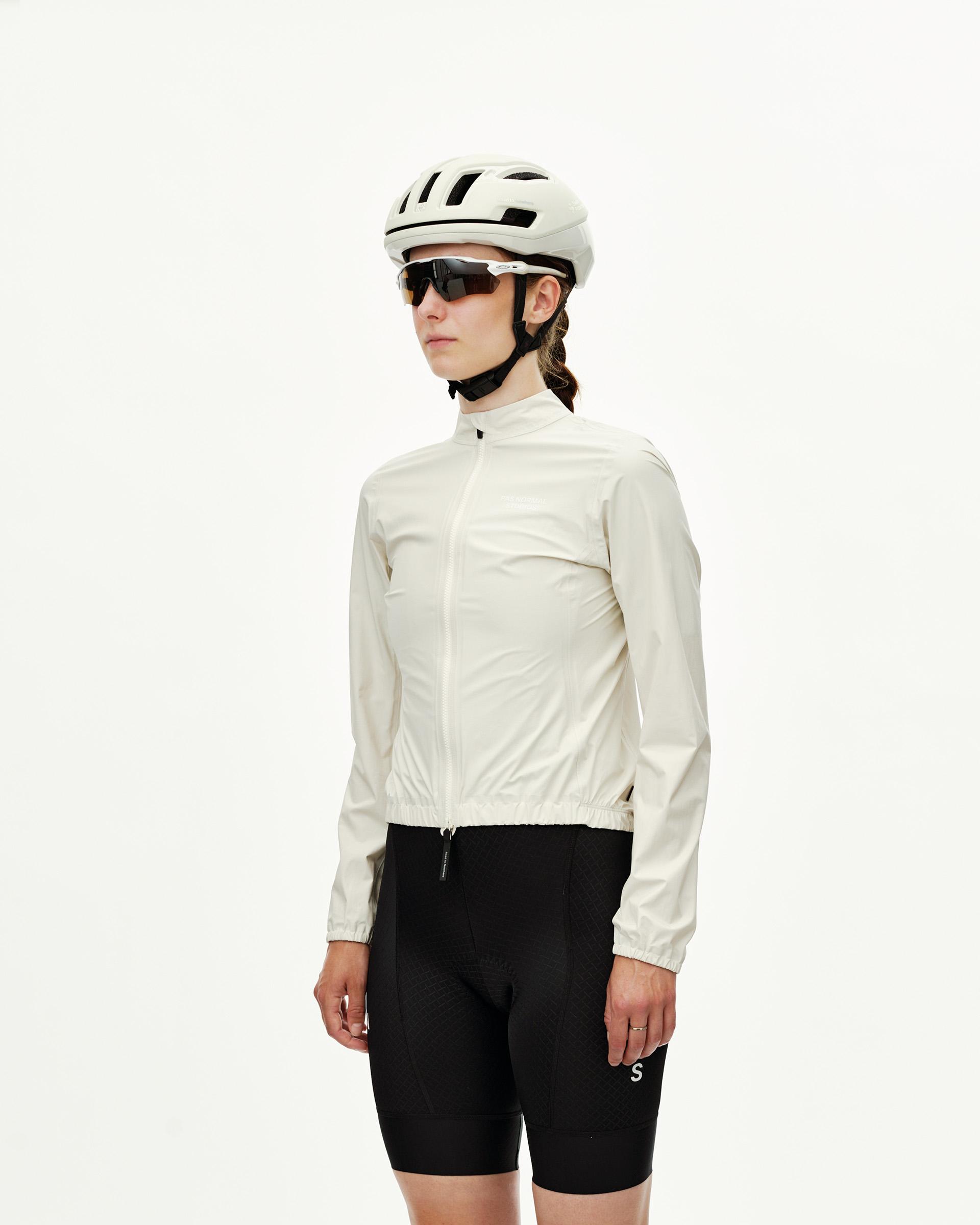 Off White Mechanism women's cycling rain jacket on model, three-quarter front view with full zip and elastic hem