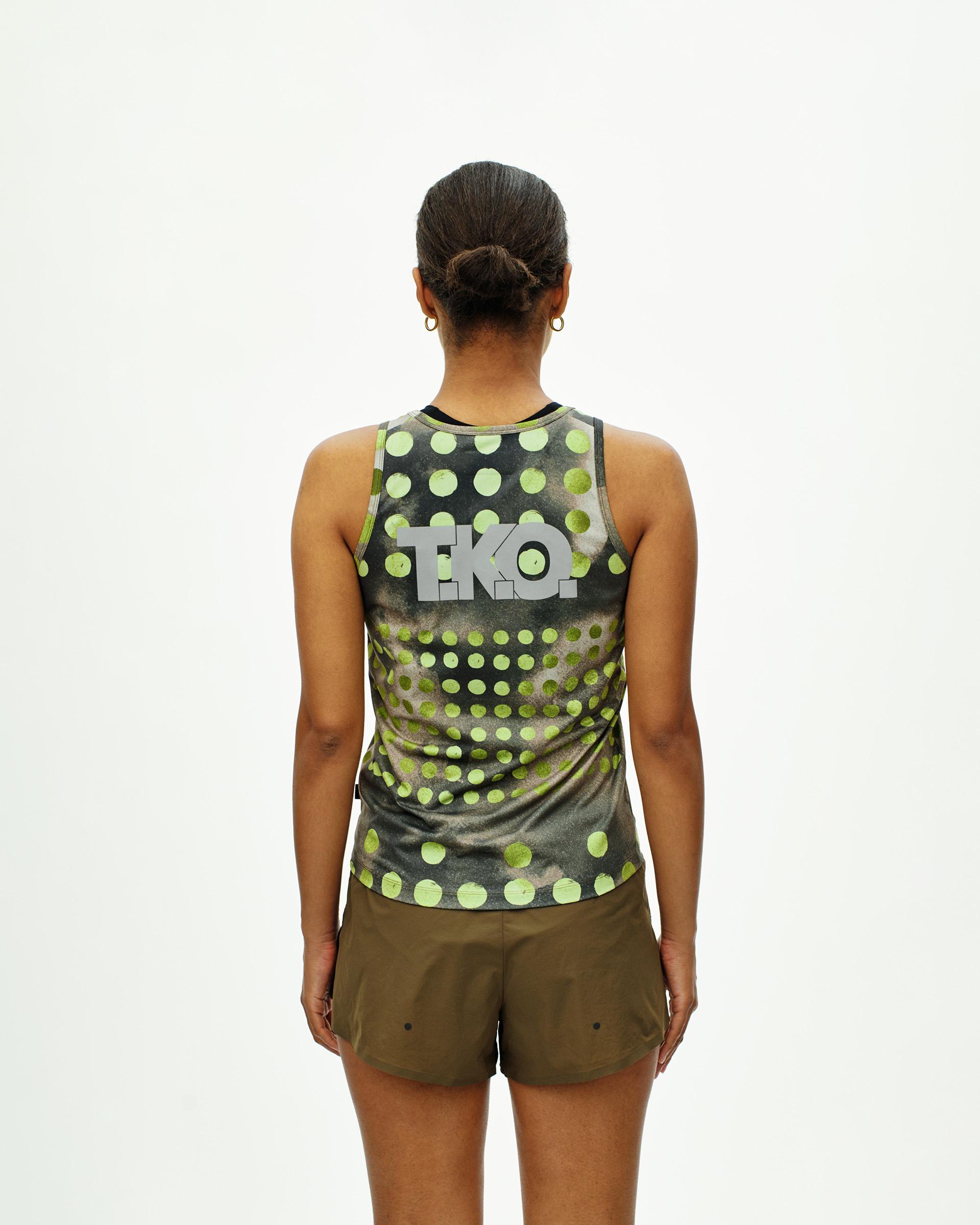 Green T.K.O. Balance singlet on model, rear view with polka dot print and T.K.O. logo