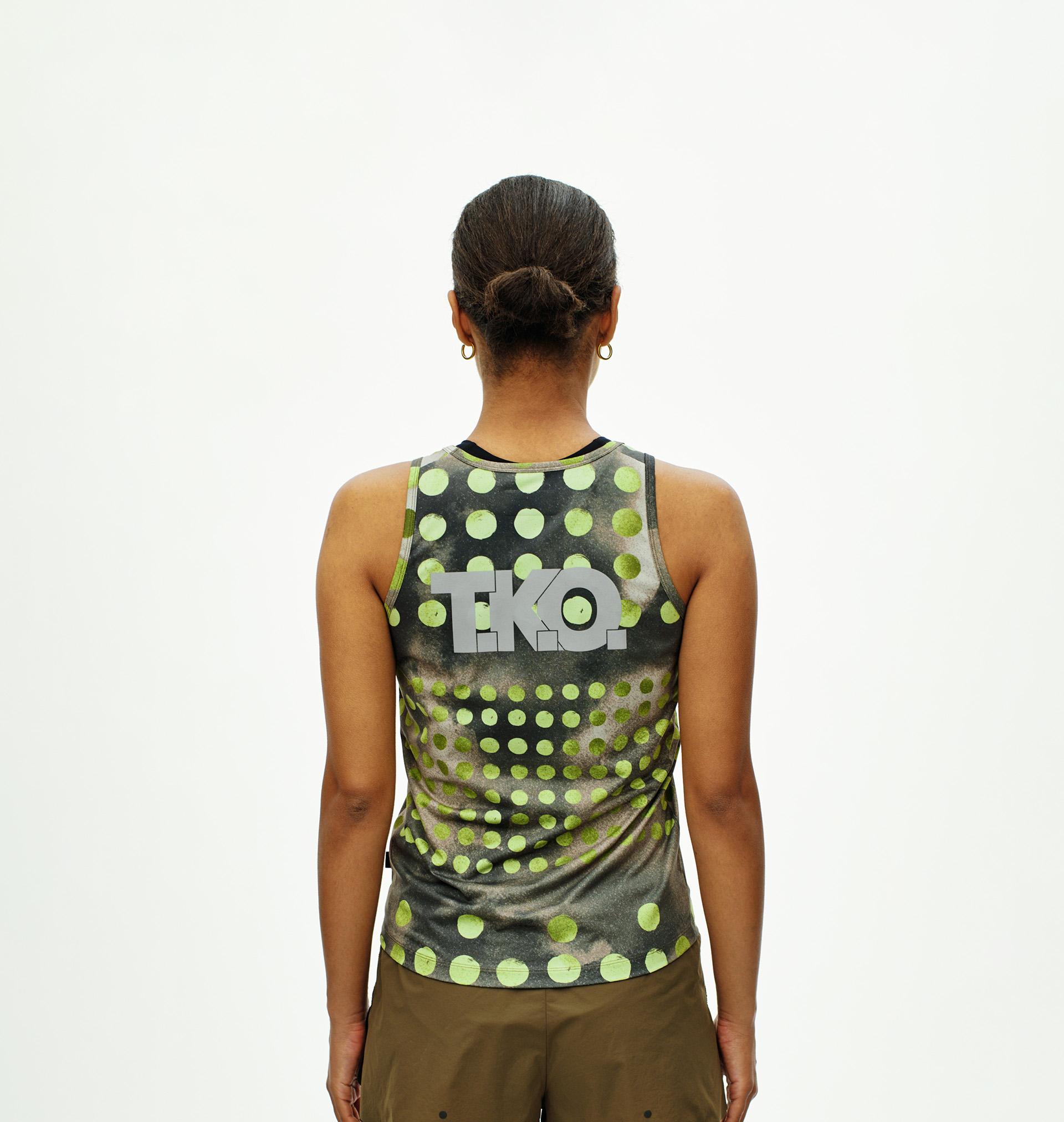 Green T.K.O. Balance singlet on model, rear view with polka dot print and T.K.O. logo