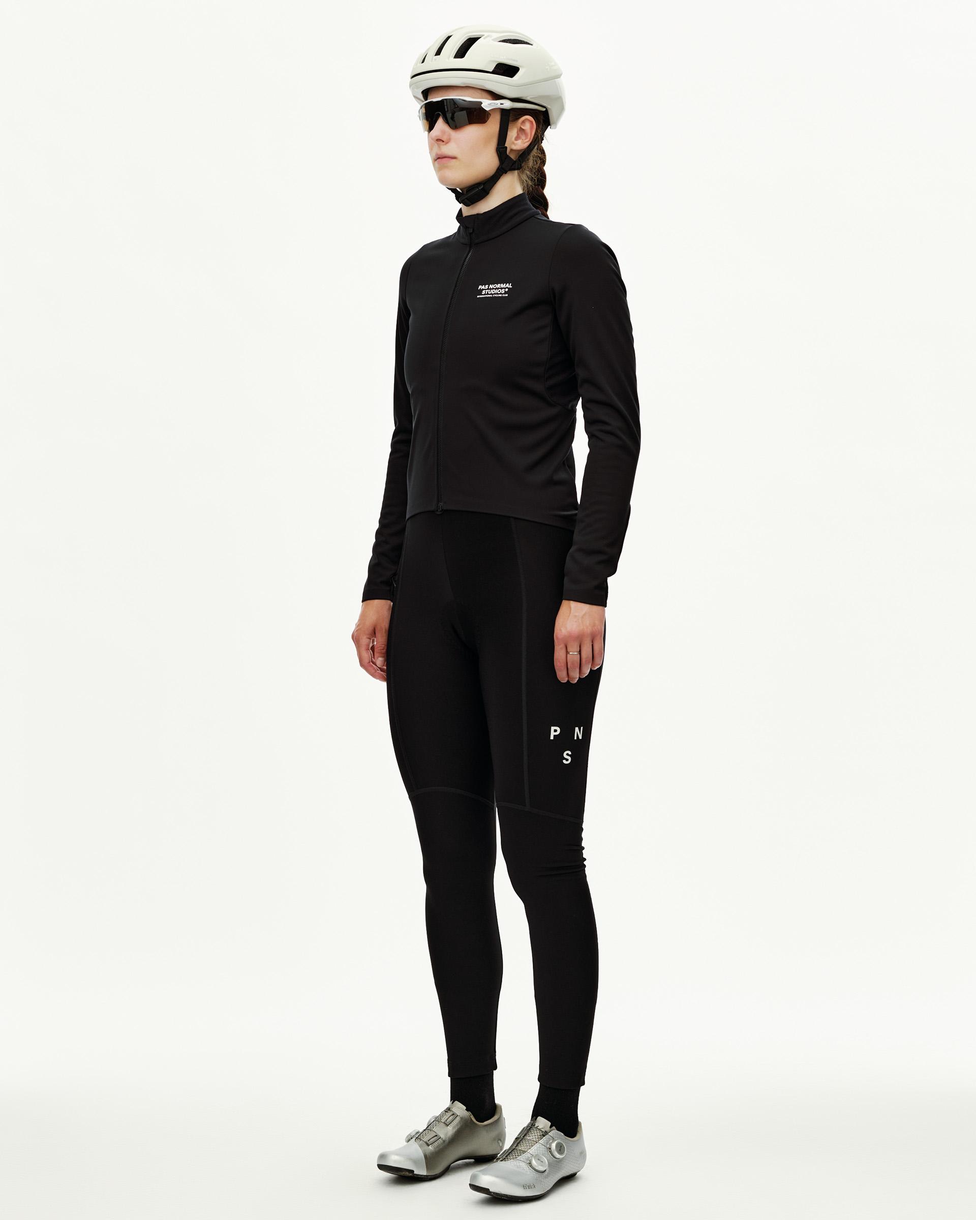 Black Mechanism Thermal Long Sleeve cycling jersey on model, three-quarter front view with chest logo print
