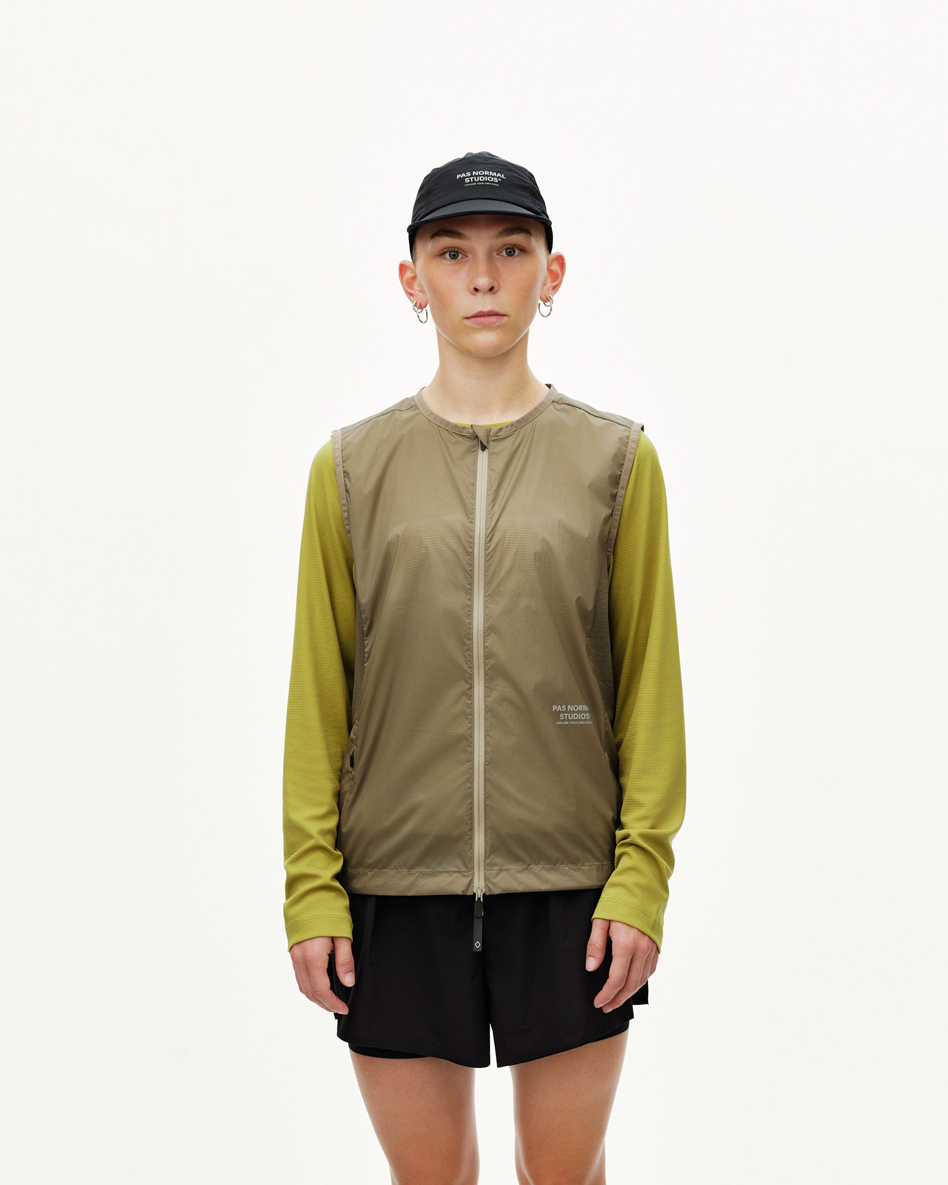Dusty Earth khaki Balance Windproof Vest on model, front view with full zip and collarless neckline