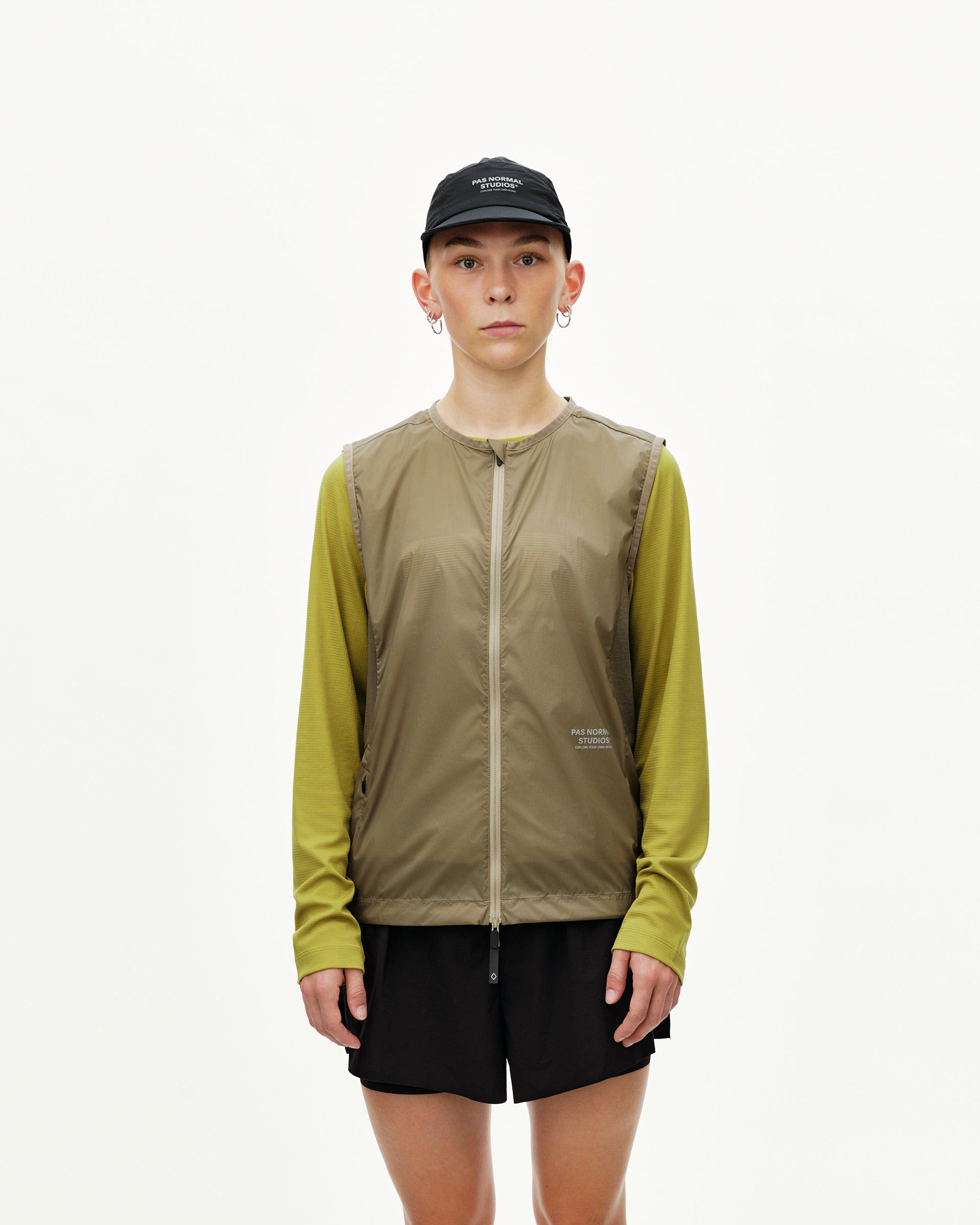 Dusty Earth khaki Balance Windproof Vest on model, front view with full zip and collarless neckline