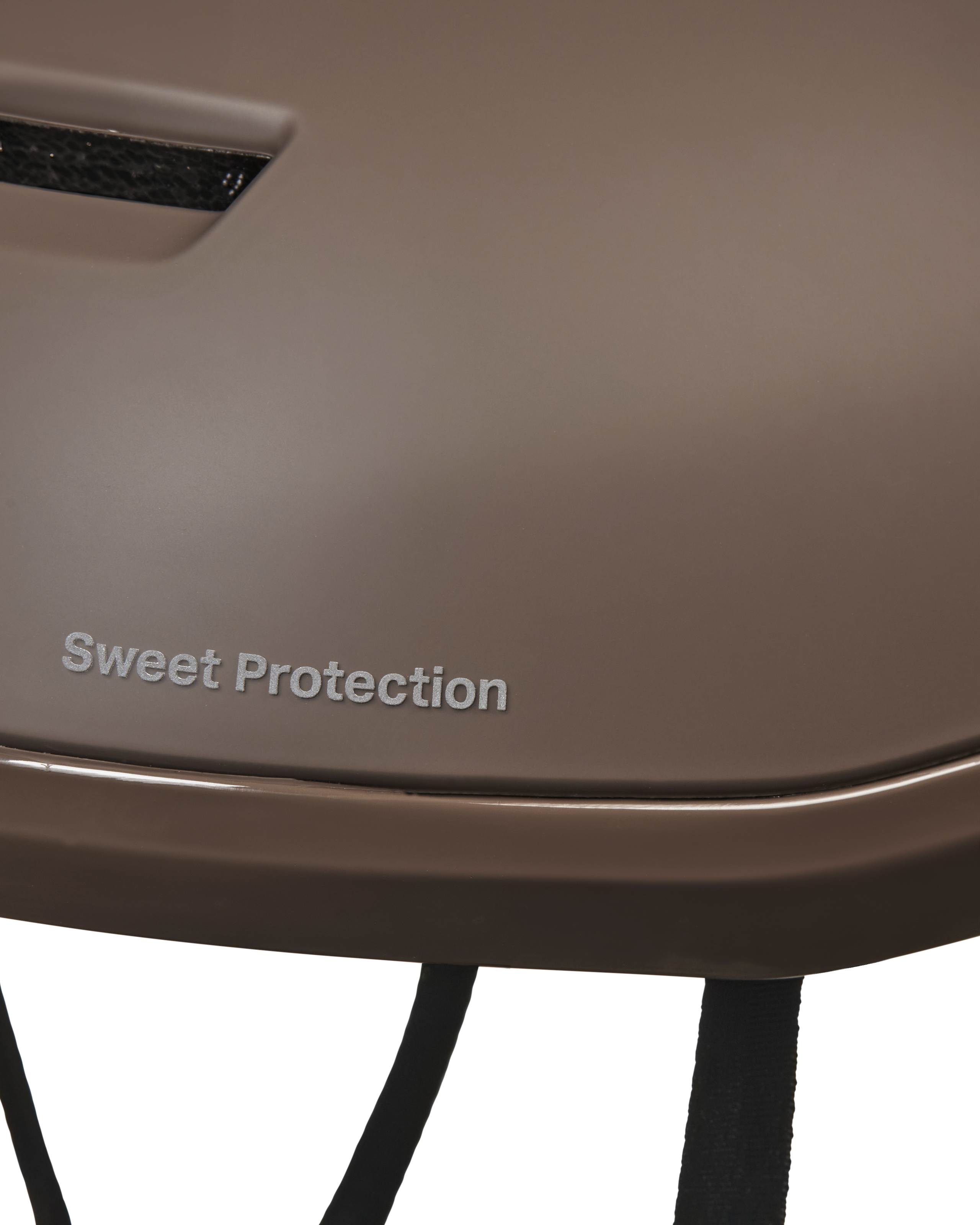 Brown Sweet Protection Commuter Mips cycling helmet, side detail view with branded shell