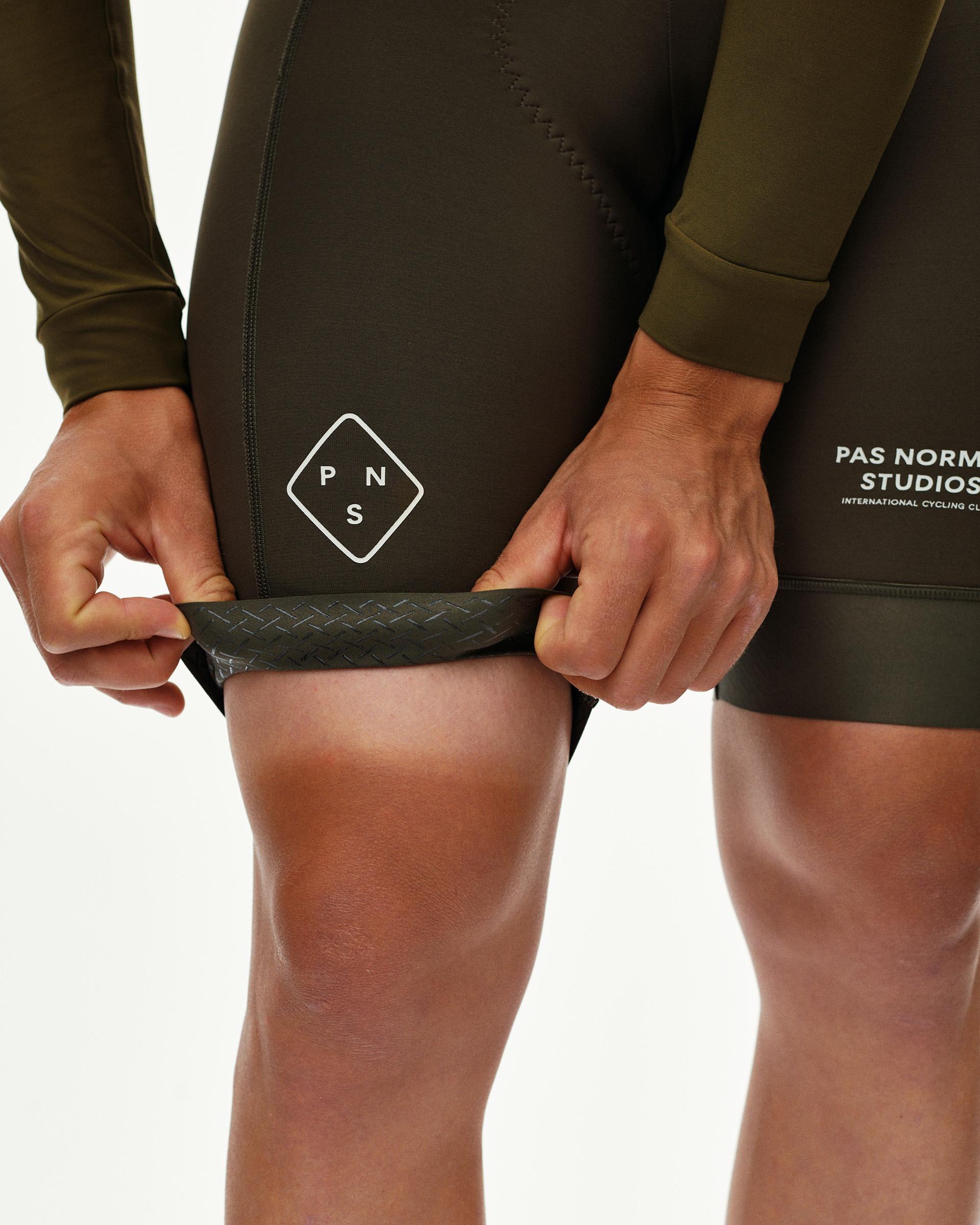 Moss Brown PAS men's thermal speedsuit, detail view of leg hem with textured gripper band on model