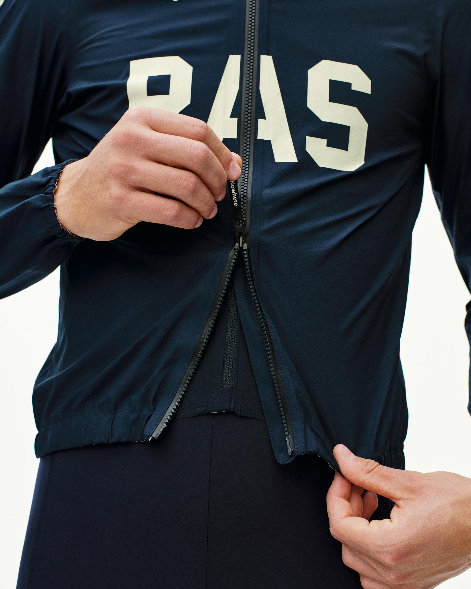 Navy PAS Mechanism Rain cycling jacket on model with white chest logo and full zip