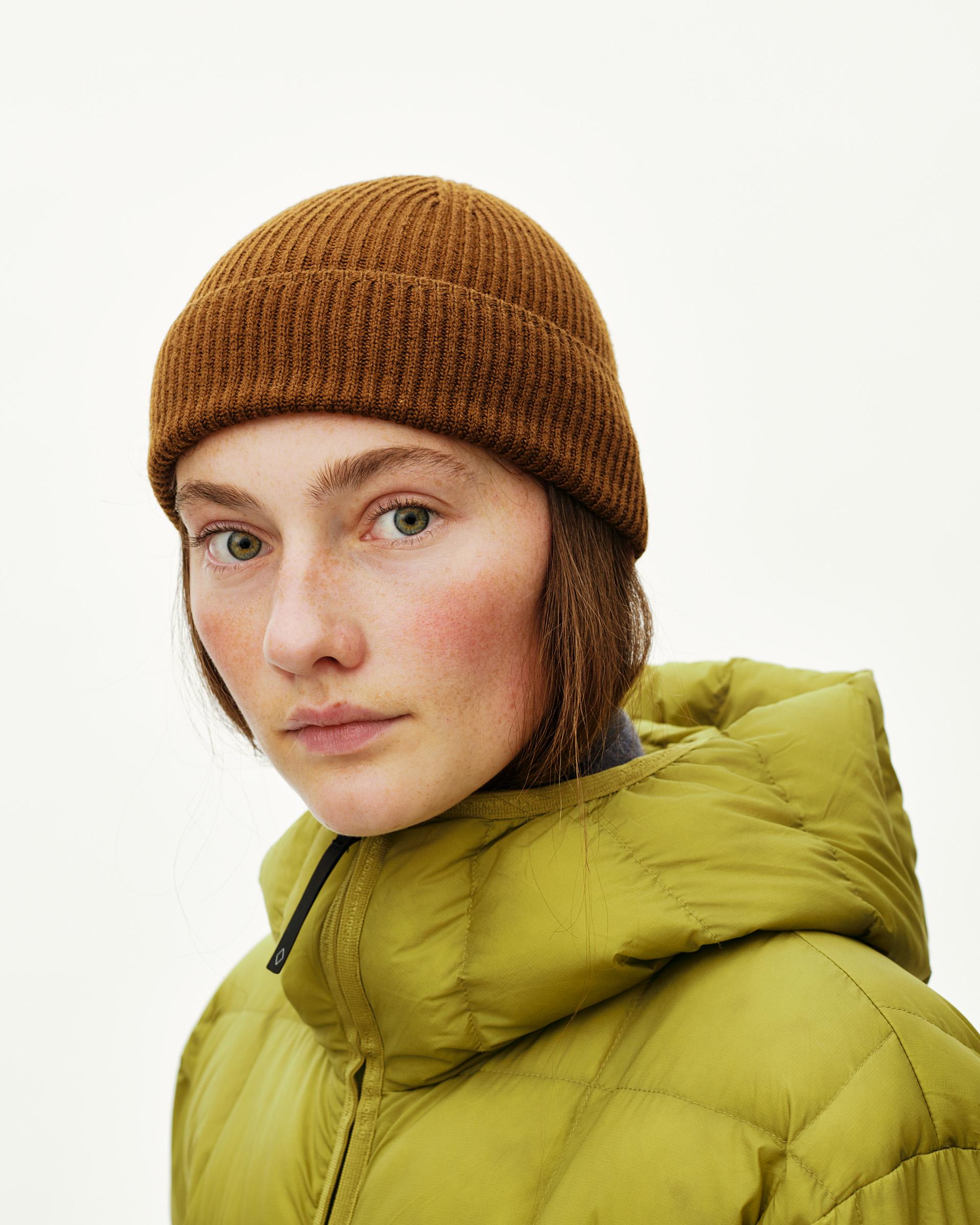 Wood brown Off-Race Merino Knit beanie on model, front view with ribbed cuff