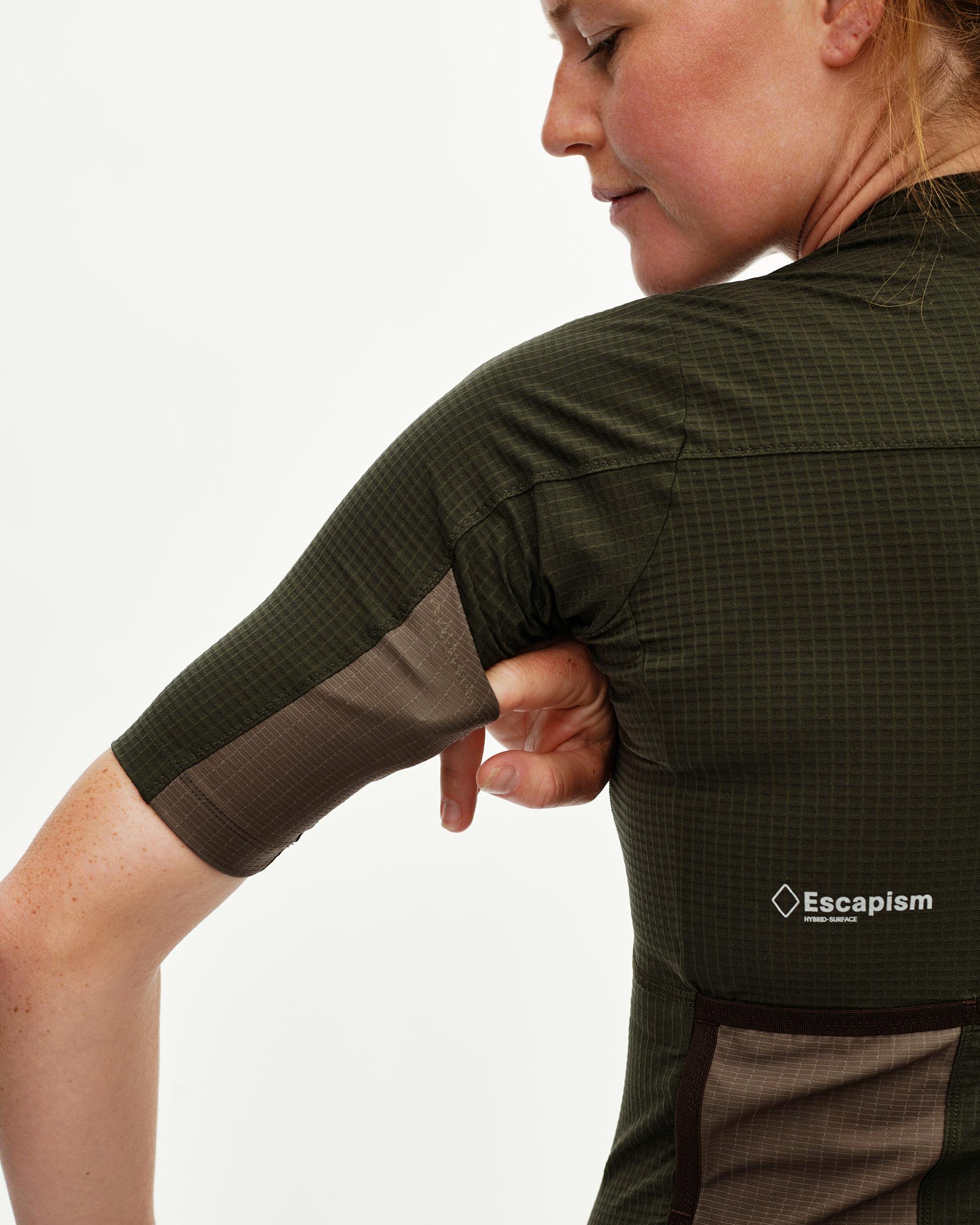 Dark Olive Escapism cycling jersey on model, rear detail view with grid fabric texture and contrast sleeve panel