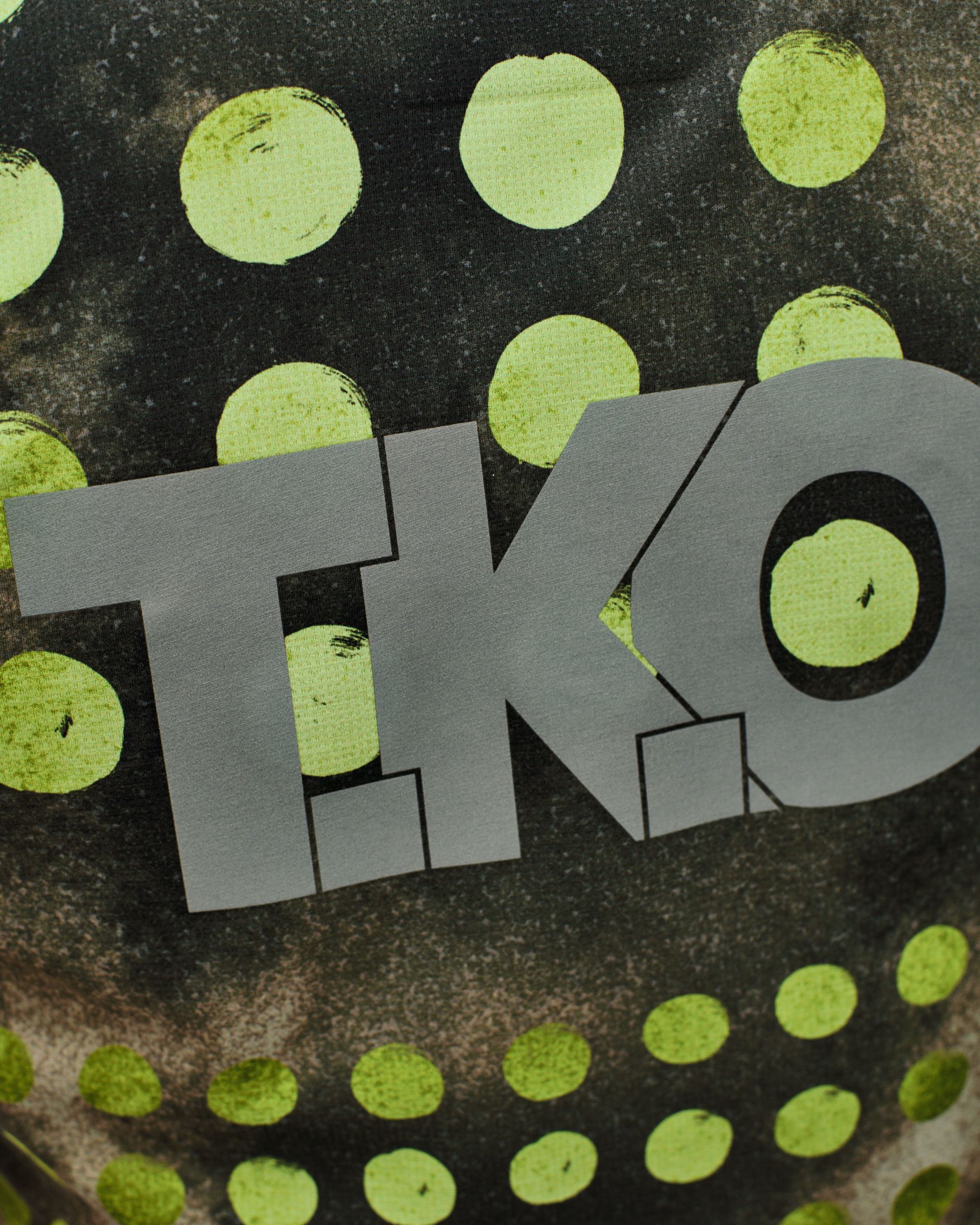Green T.K.O. Balance singlet, detail view with grey logo on printed fabric