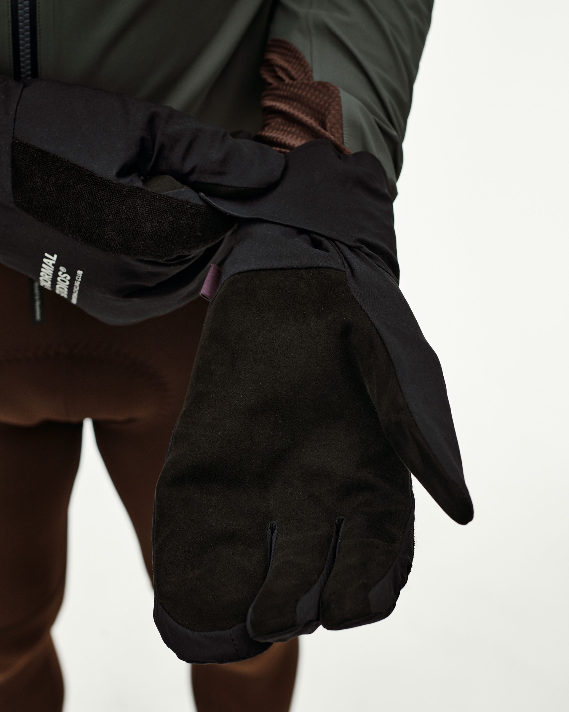 Black Logo Deep Winter Insulated cycling gloves, palm detail on model with suede palm and velcro wrist strap
