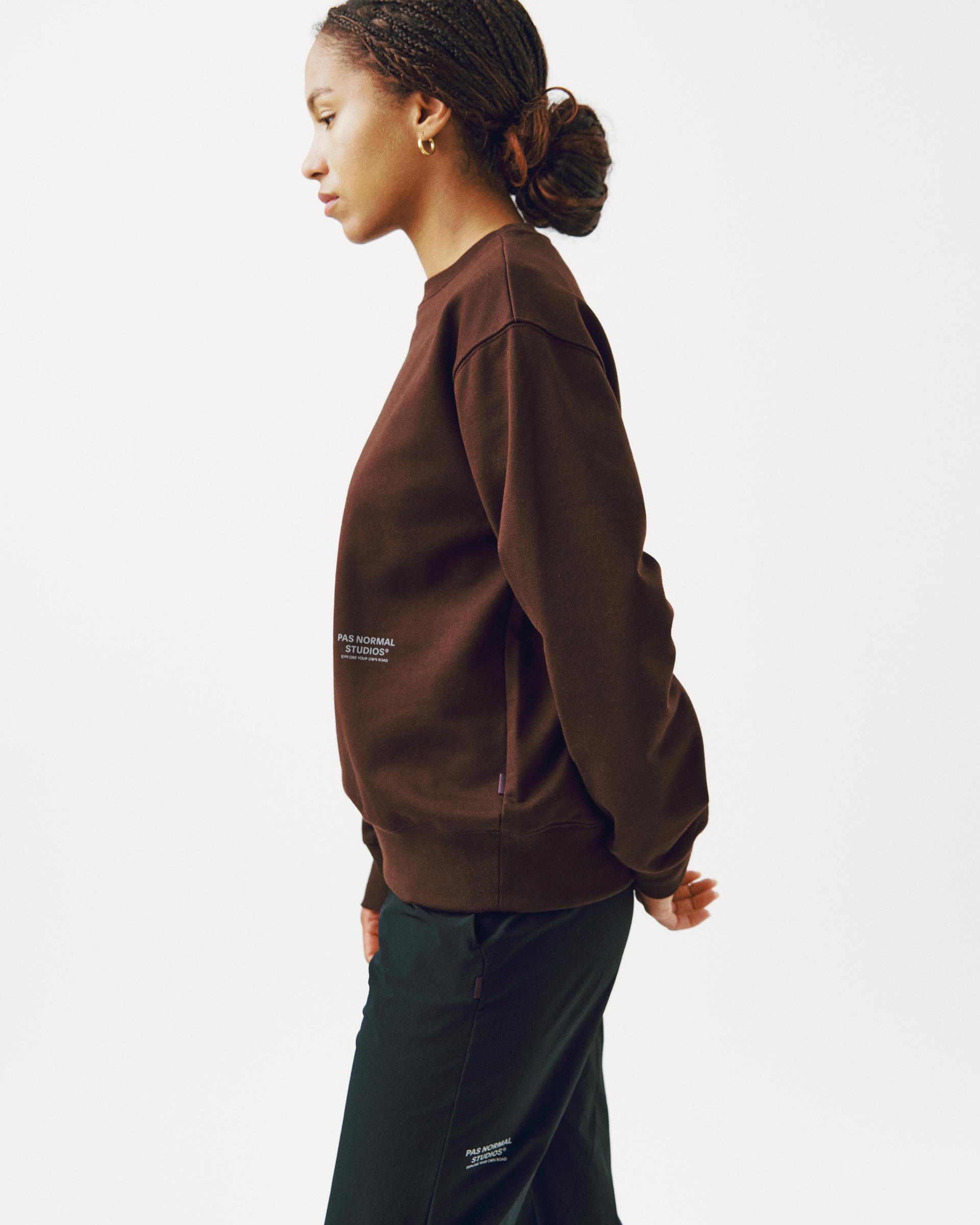Brown Off-Race sweatshirt on model, side view with white logo patch