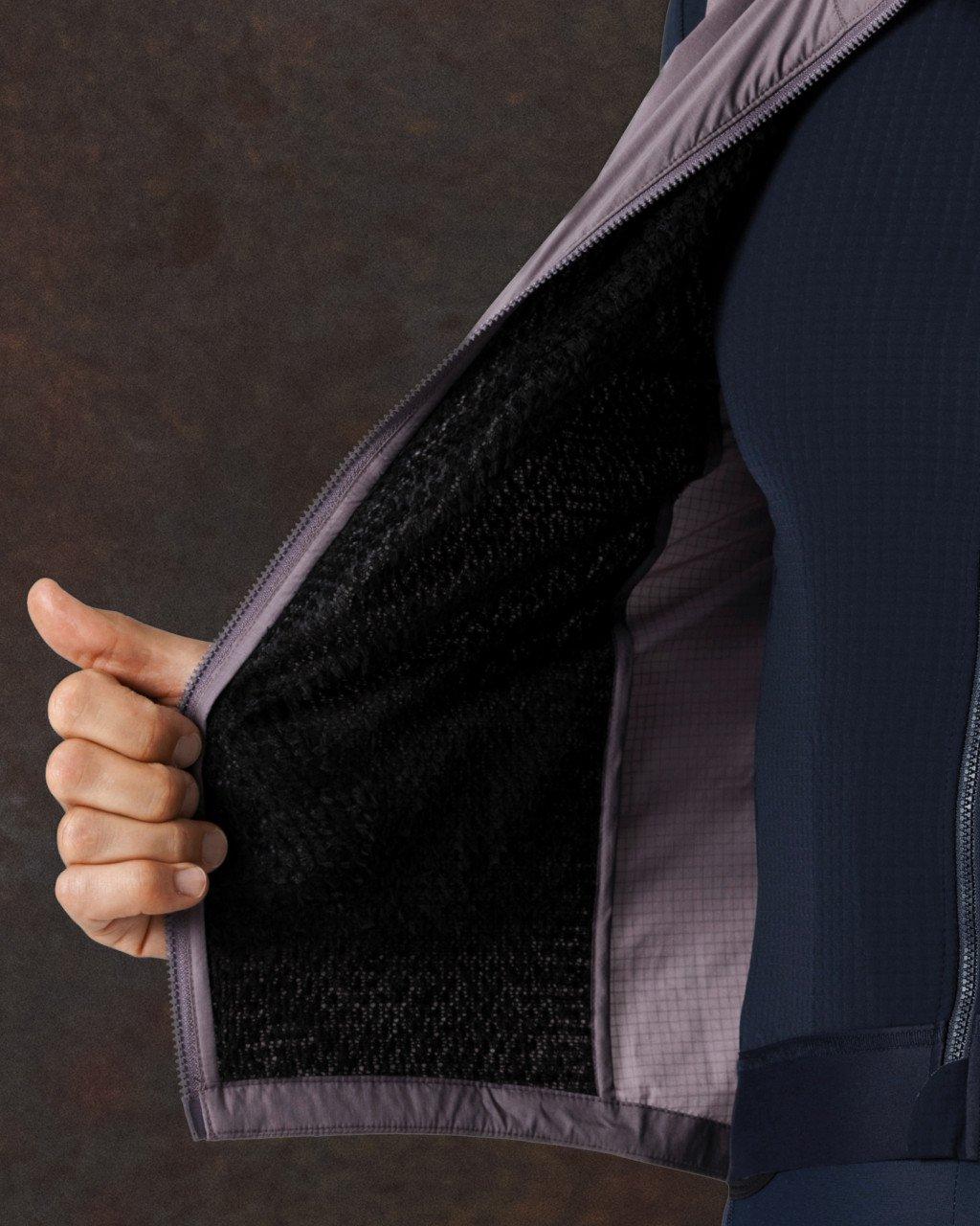 Model showing interior of purple jacket with black mesh lining and front zip closure