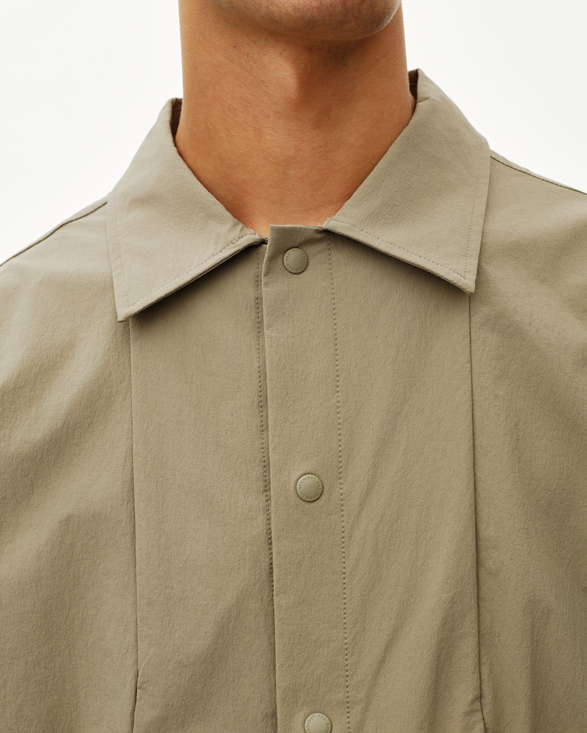 Dusty Earth khaki Off-Race Tech Overshirt, front detail on model with snap buttons and point collar