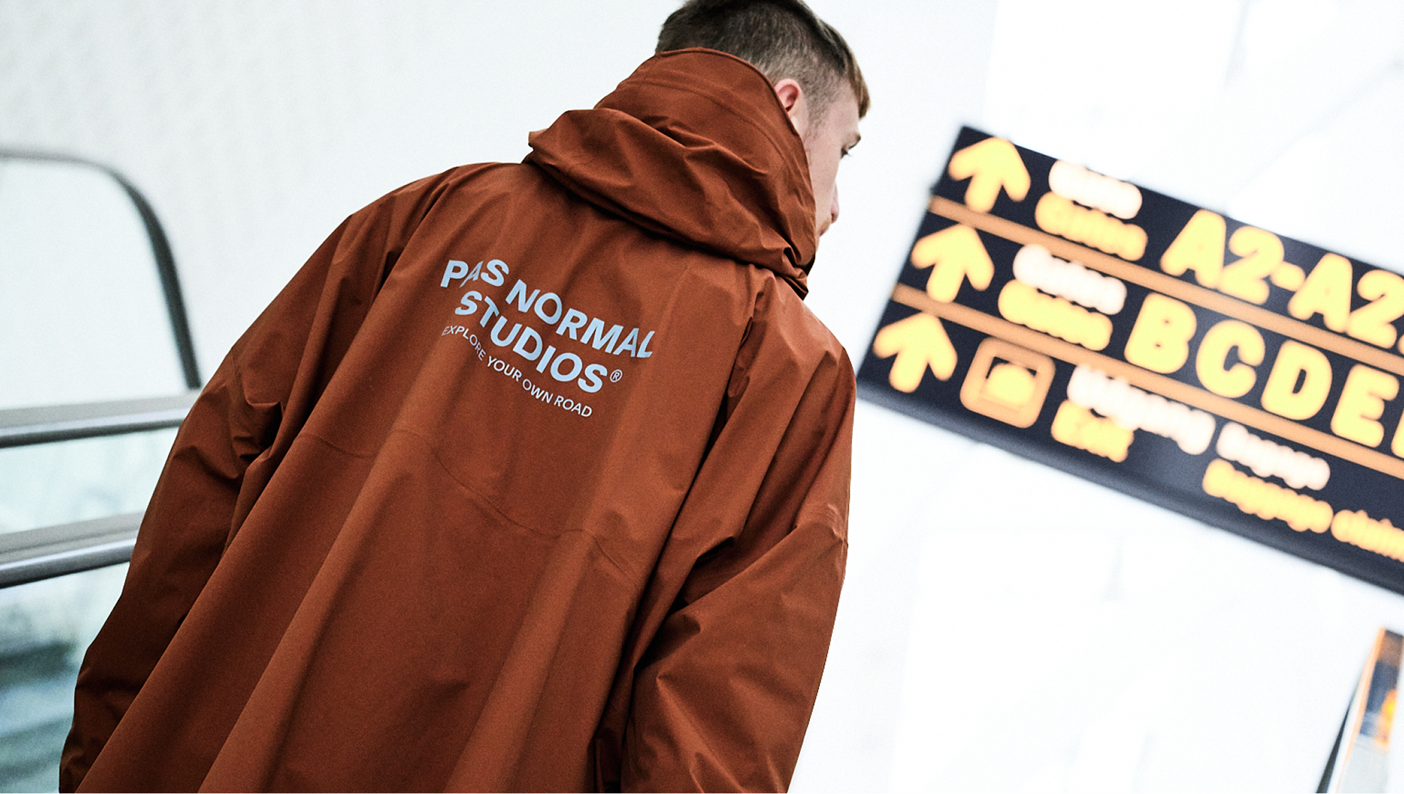 Model wearing Off-Race hoodie in rust brown with back branding, shown from behind