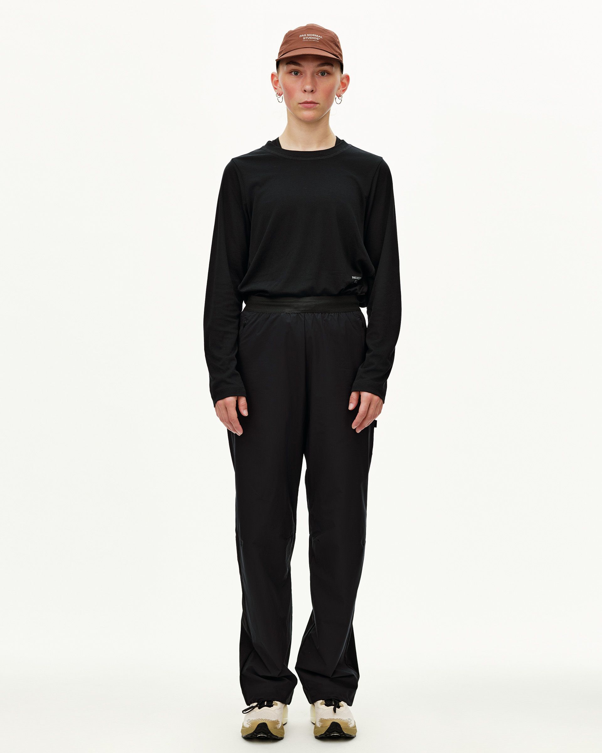 Black Balance Performance pants on model, front view with elastic waistband and side pockets