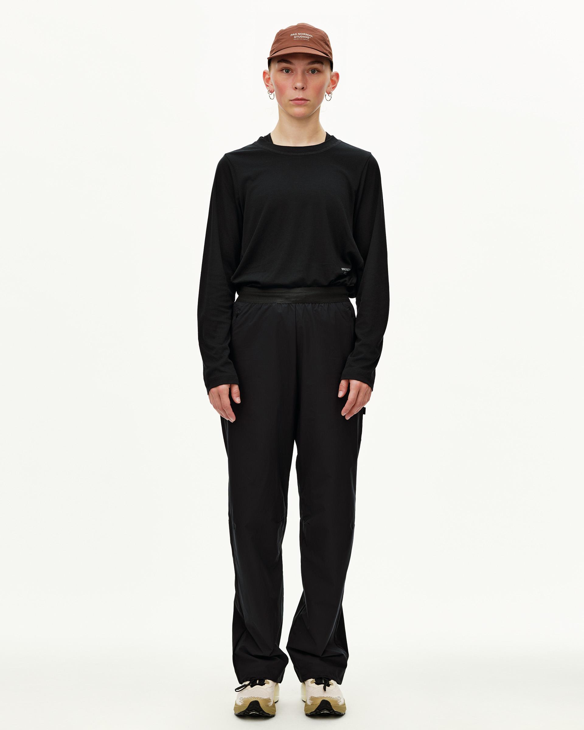 Black Balance Performance pants on model, front view with elastic waistband and side pockets