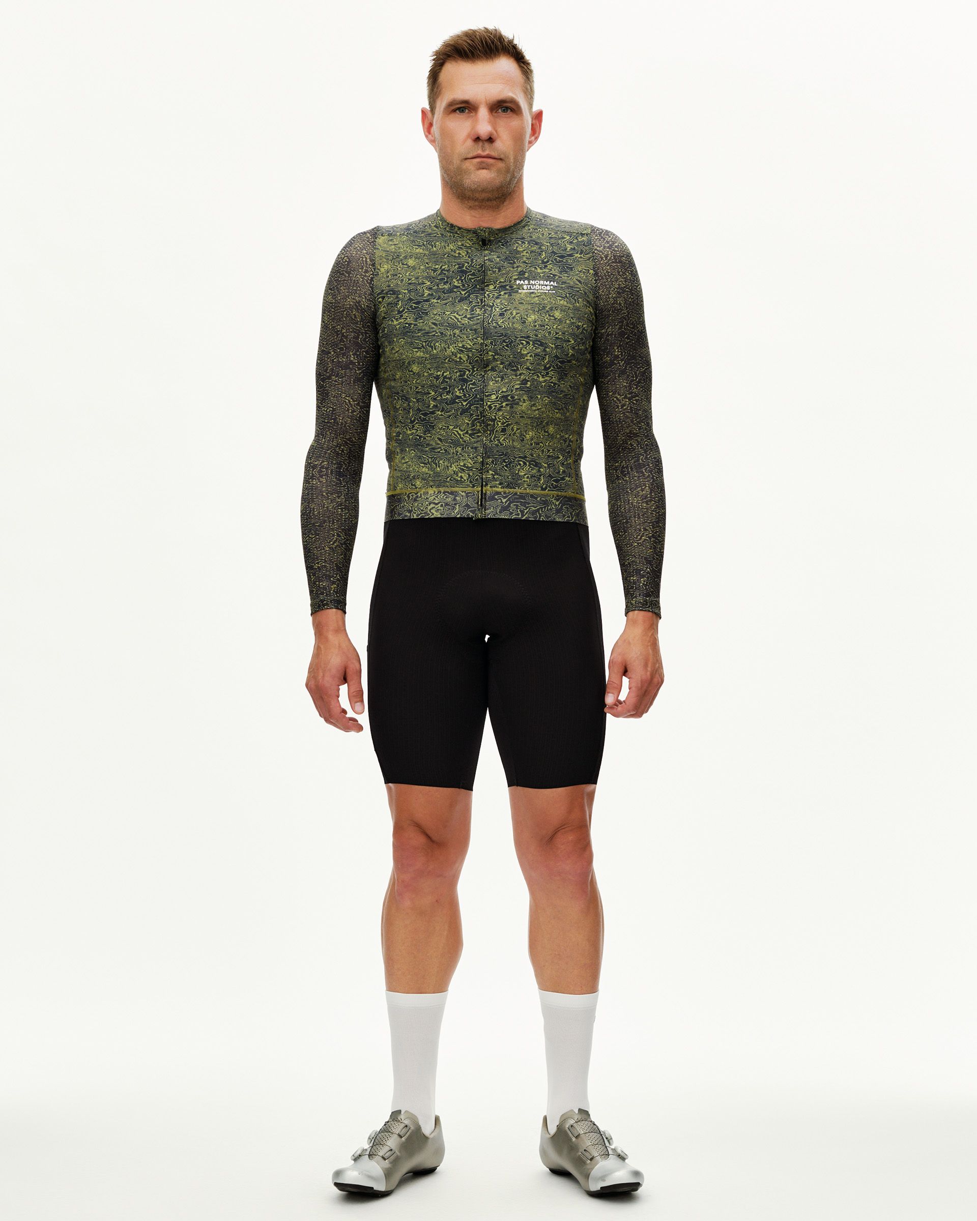 Dark Lime Essential long sleeve cycling jersey on model, front view with all-over swirl print