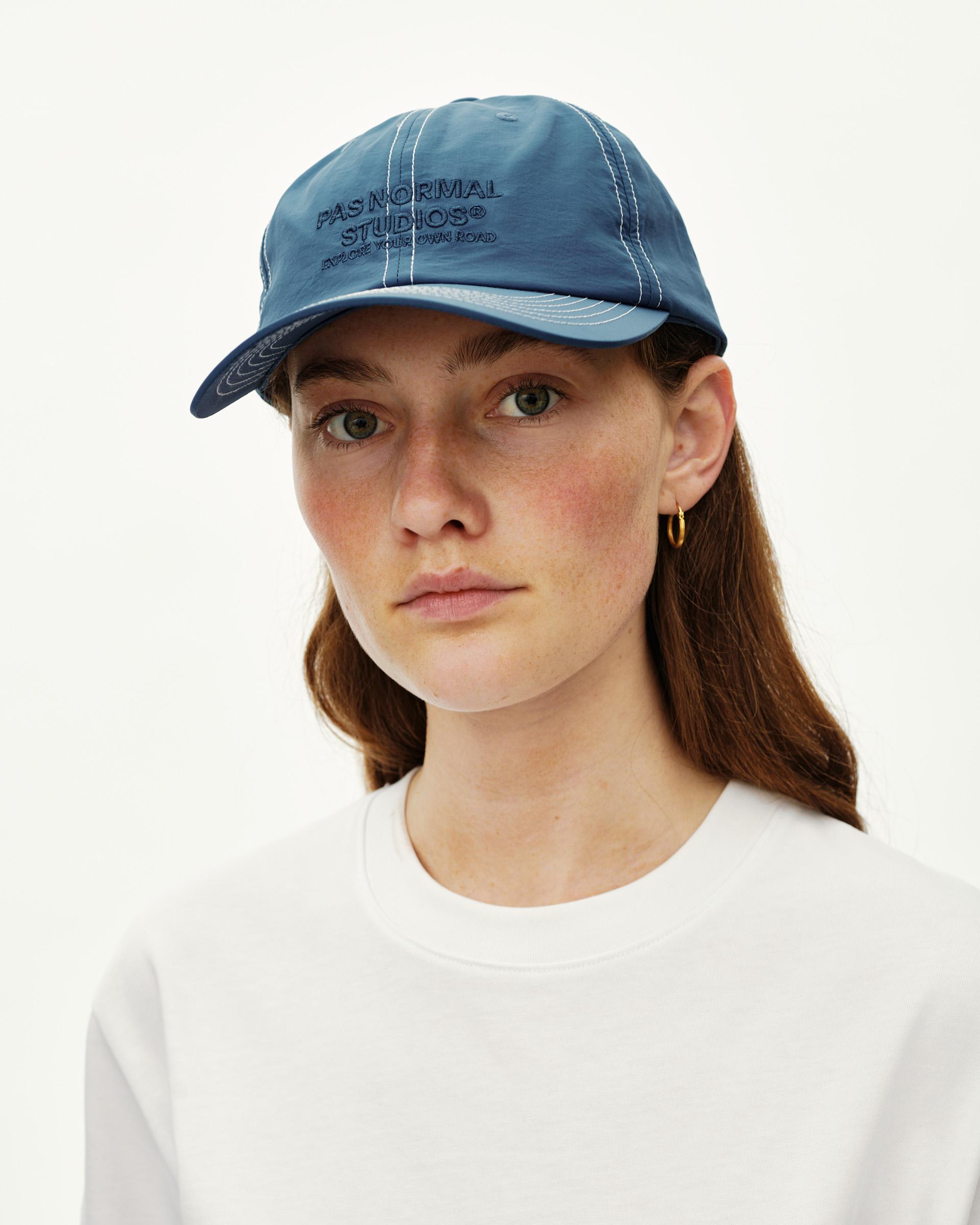 Ocean Blue Off-Race cap on model, front view with contrast white stitching and embroidered chest logo