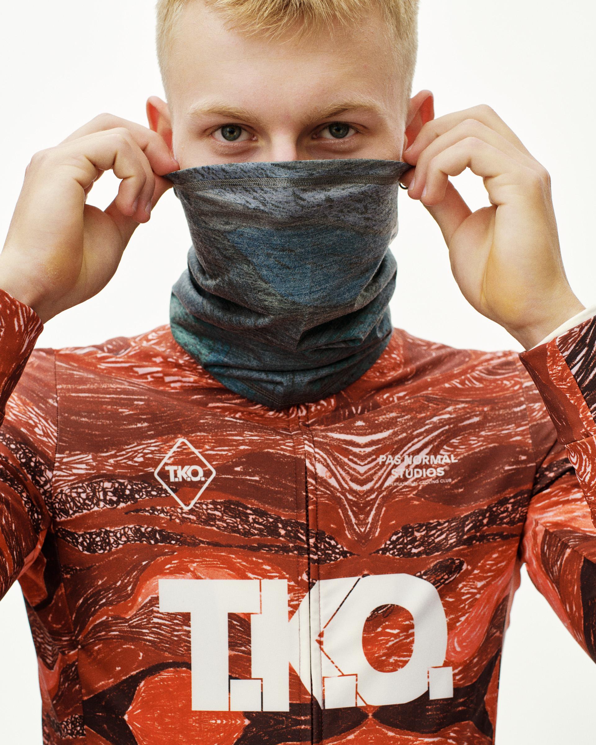 Dark Multi T.K.O. Merino necktube on model, pulled up over face showing marbled blue-grey pattern