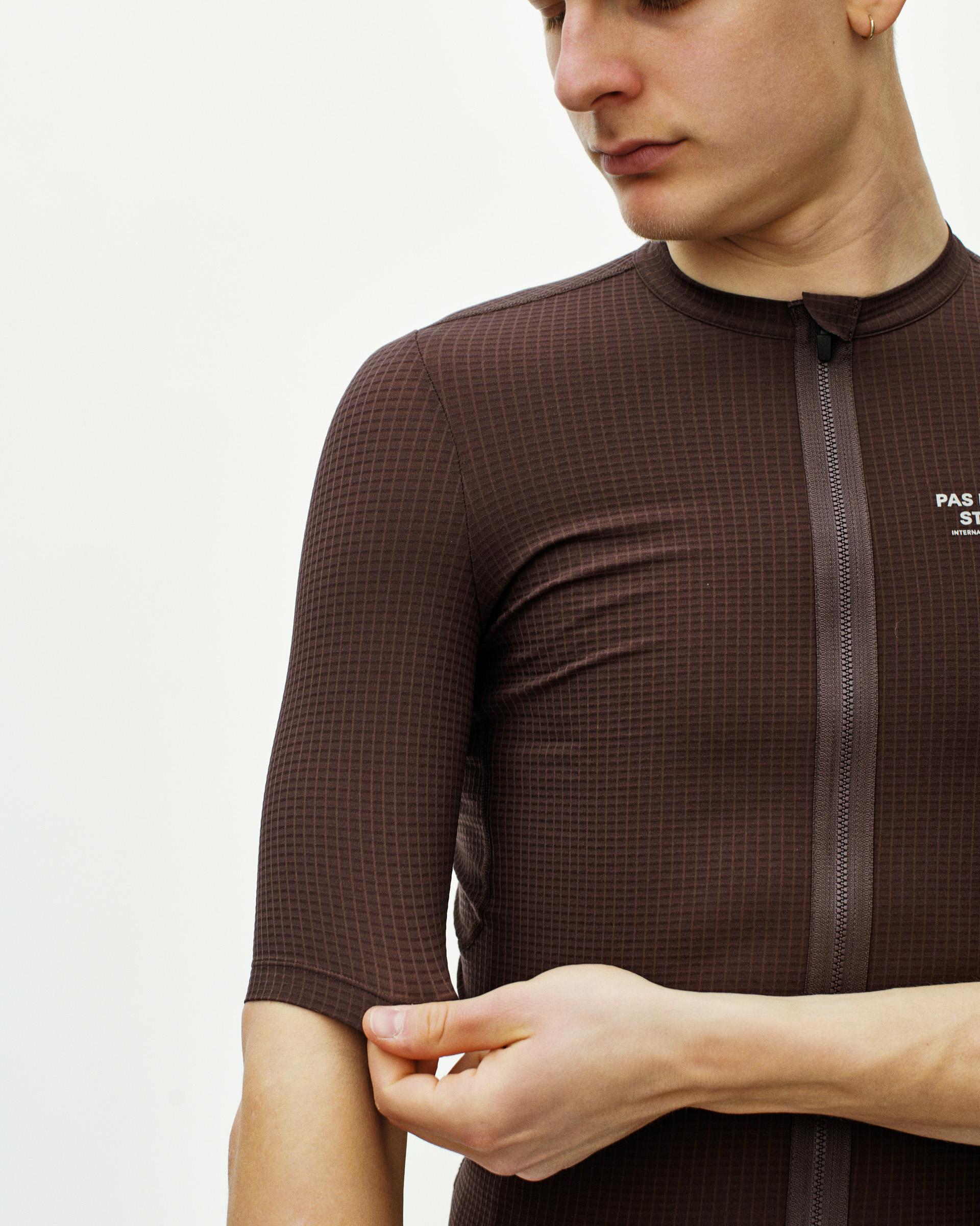 Dark Red Escapism cycling jersey on model with checkered pattern and full zip