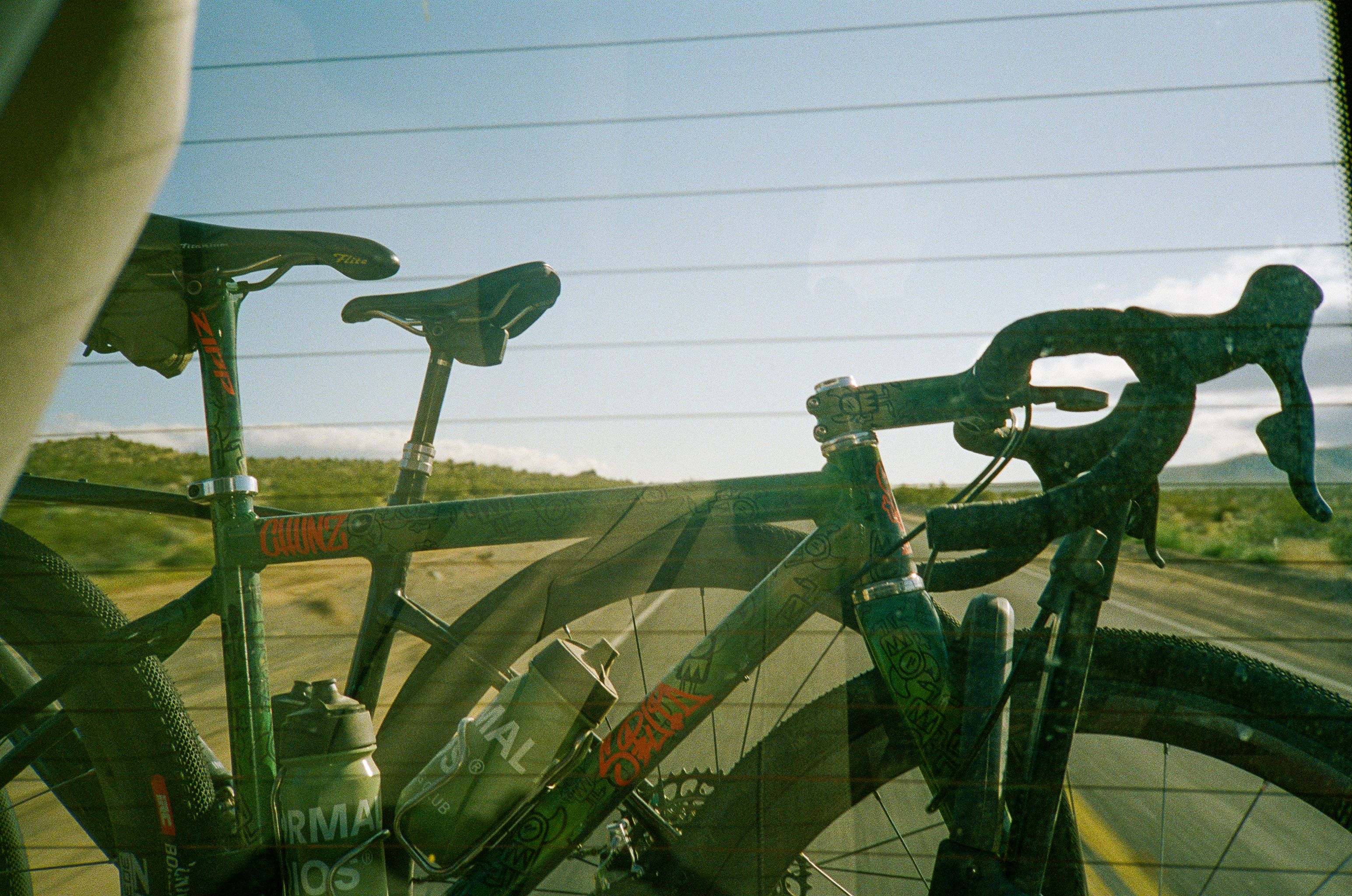 Road bike positioned against rural landscape with rolling hills and power lines in background